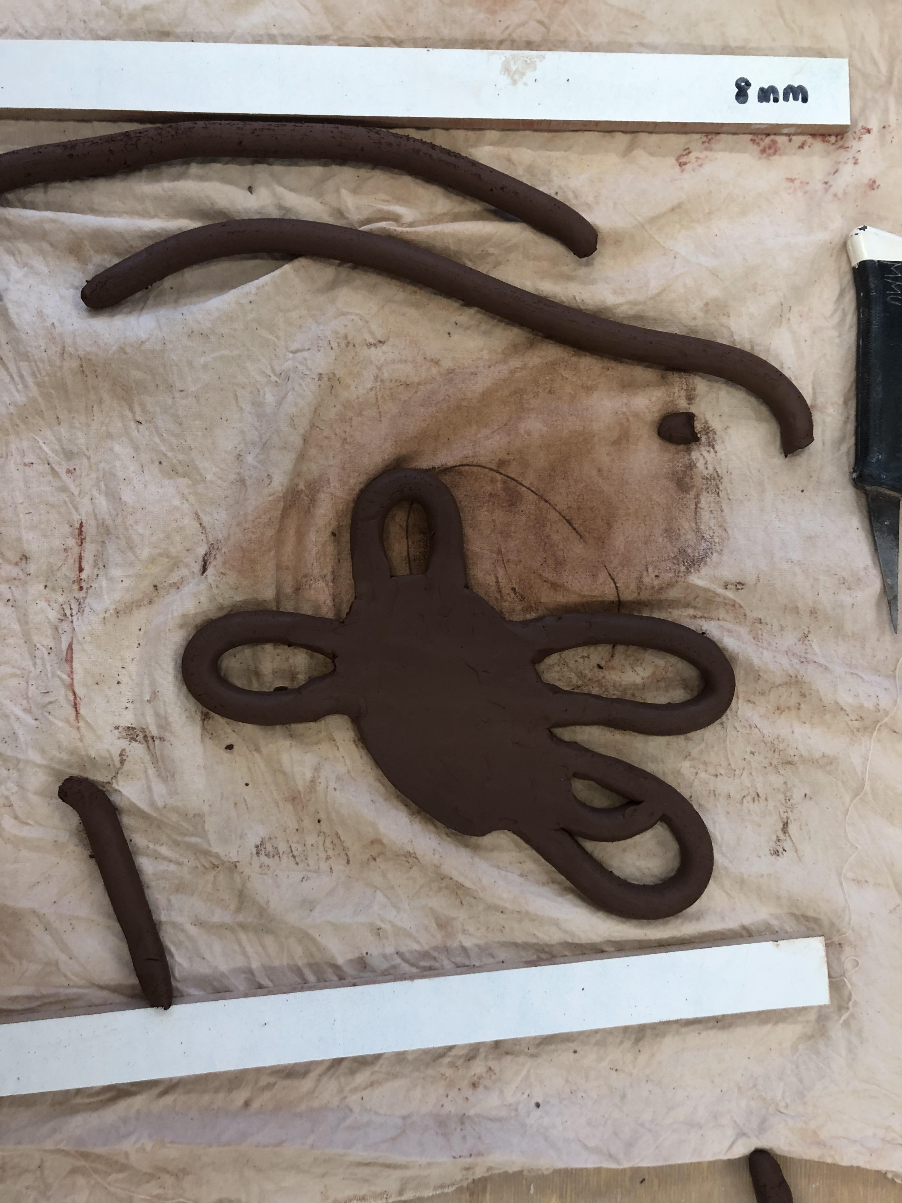 Using the extruder I had rolls of clay to attach to the centre