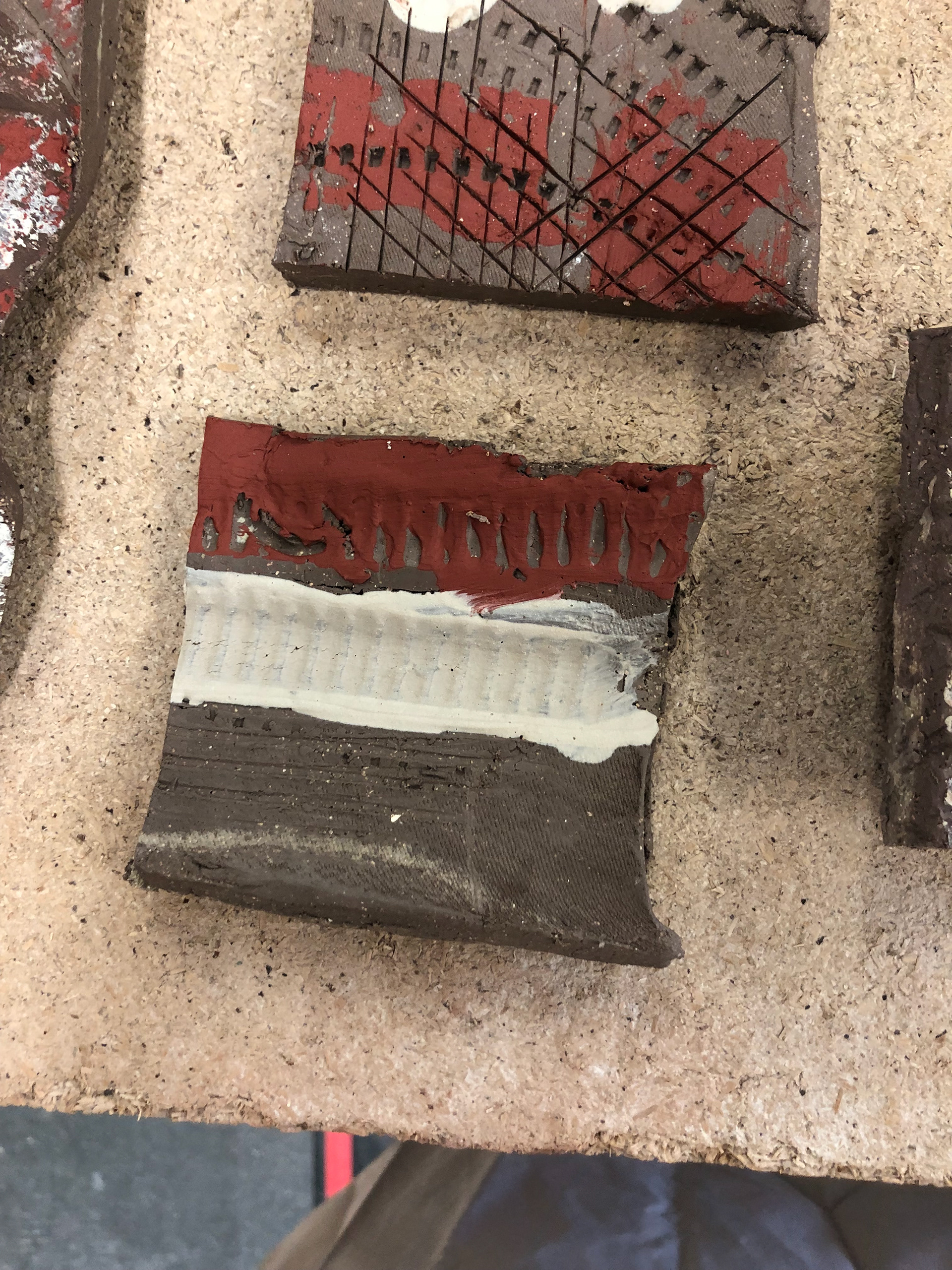 Porcelain and terracotta slip in the piping indent.