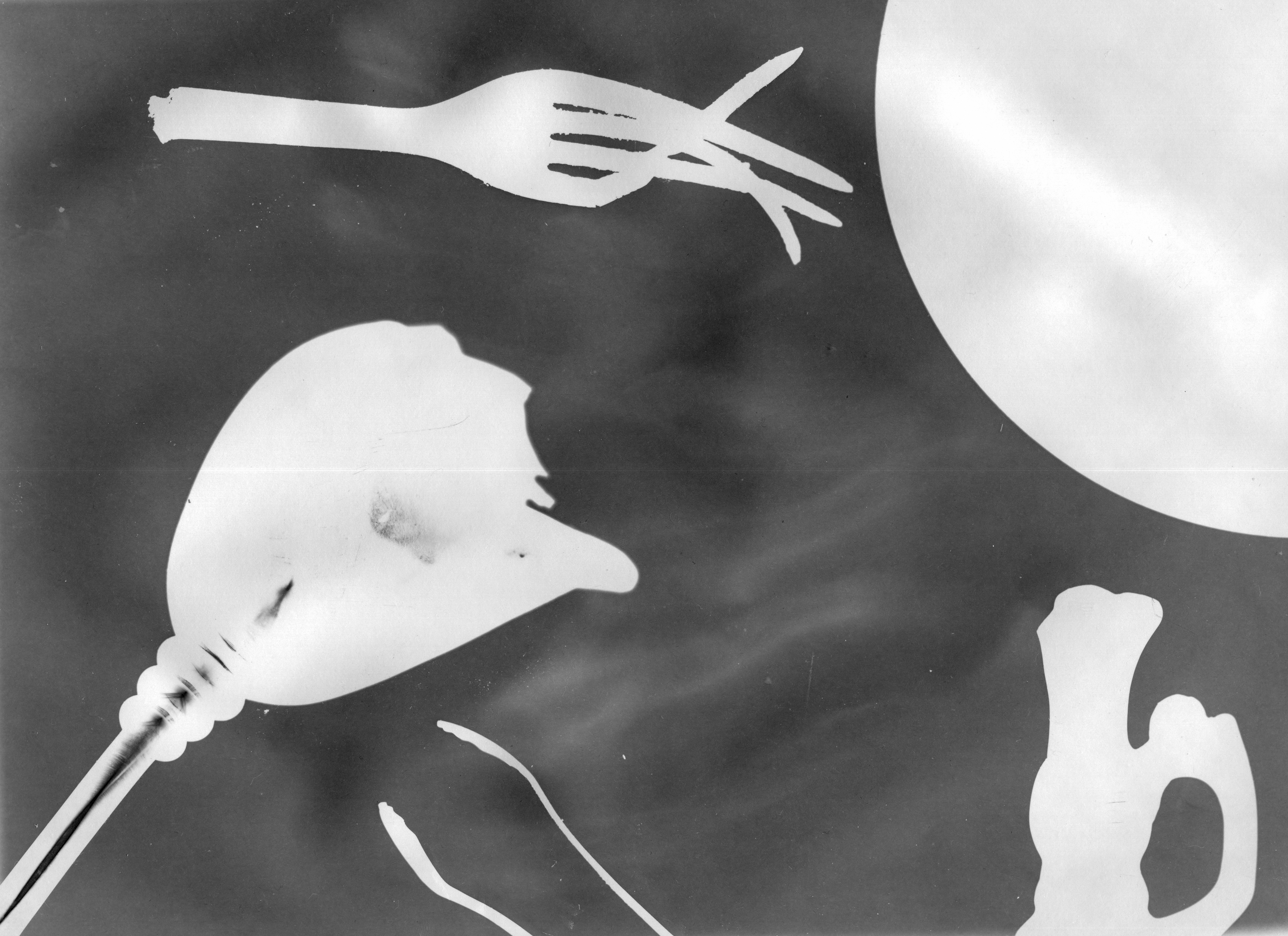 A photogram created using artifacts — coins, utensils, and other objects — found in destroyed buildings in Bucha, September 2022