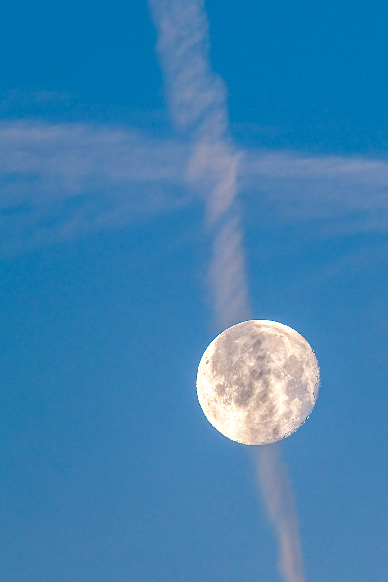 full moon and contrails