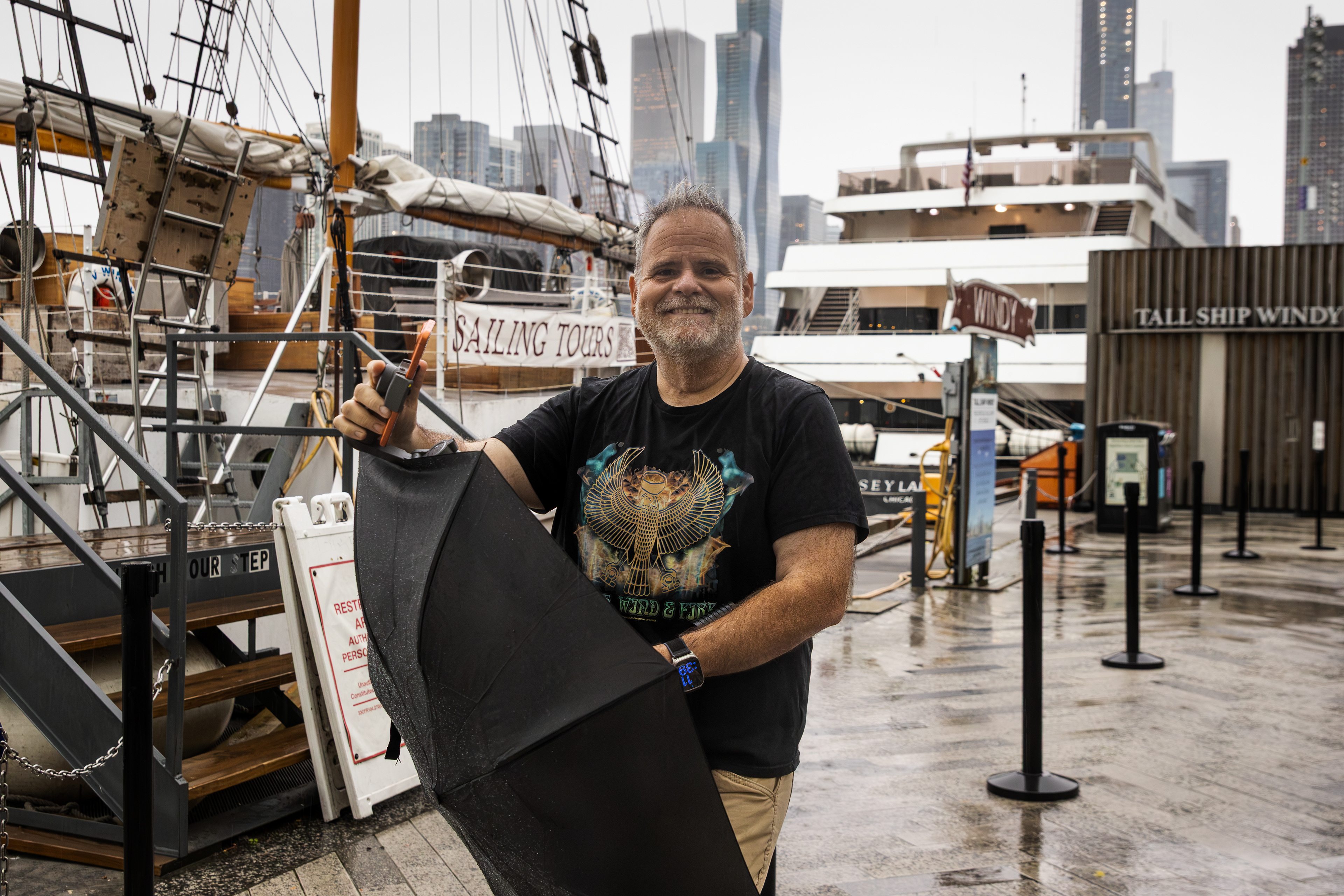 Eric Donahue, a visitor from Johnson City, Tenn., walks around Navy Pier, Chicago on Tuesday Aug. 11, 2026. A Severe Thunderstorm Warning thwarted his plan to take an architectural boat tour. | Kieran Stover/Sun-Times
