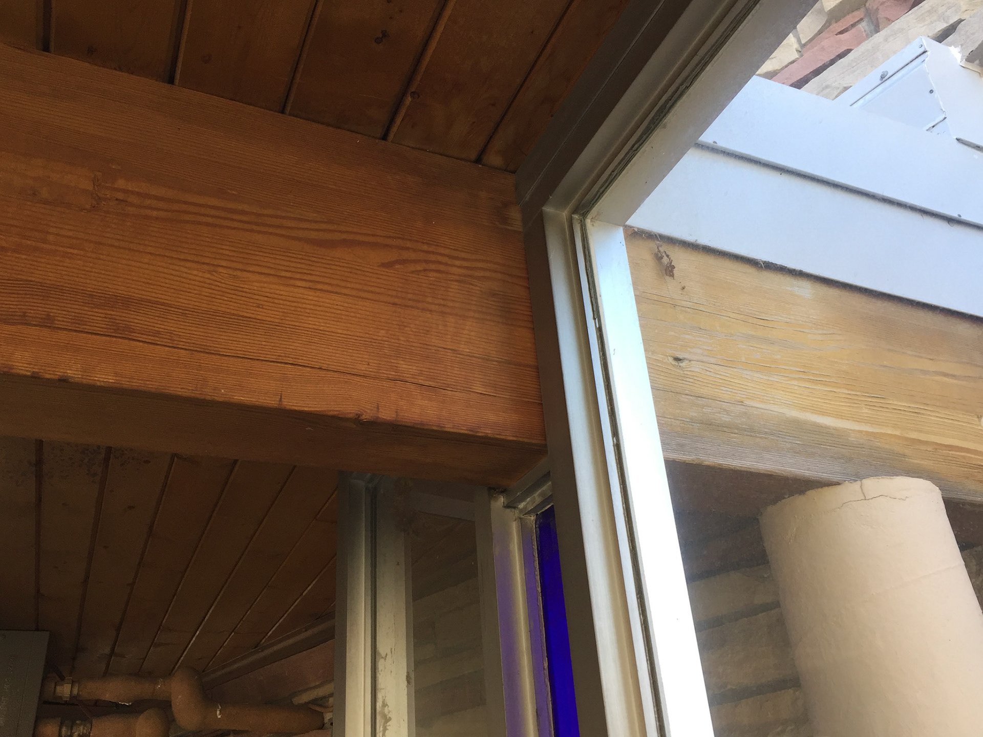 Glulam beam in south glass hallway