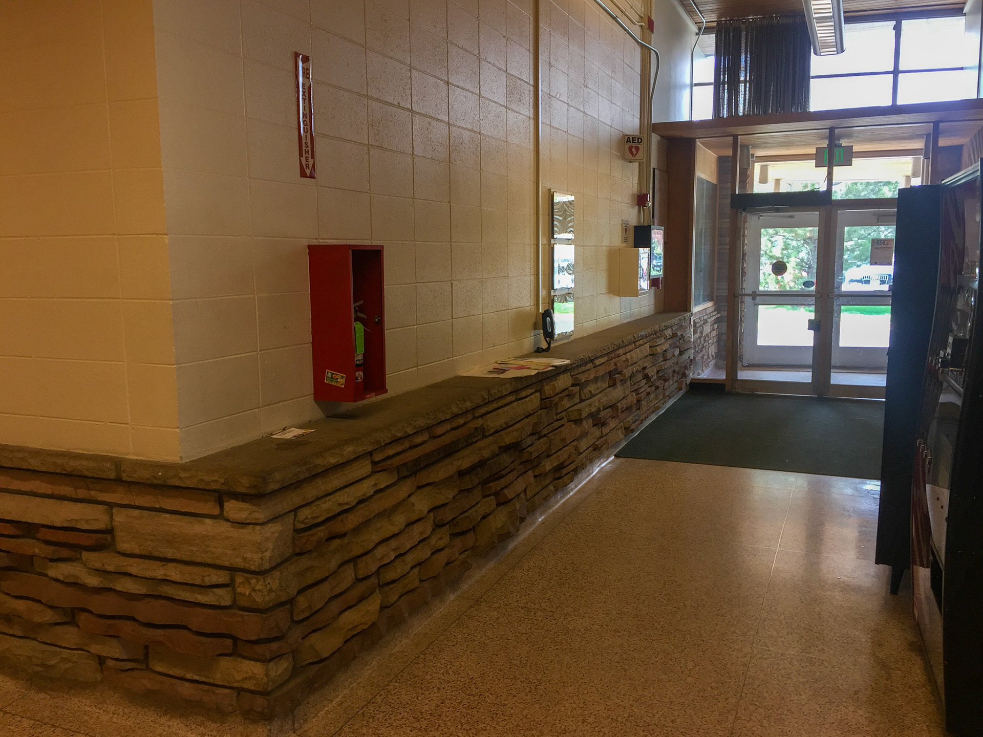 Concrete block wall built on top of original sandstone wall inside front entrance