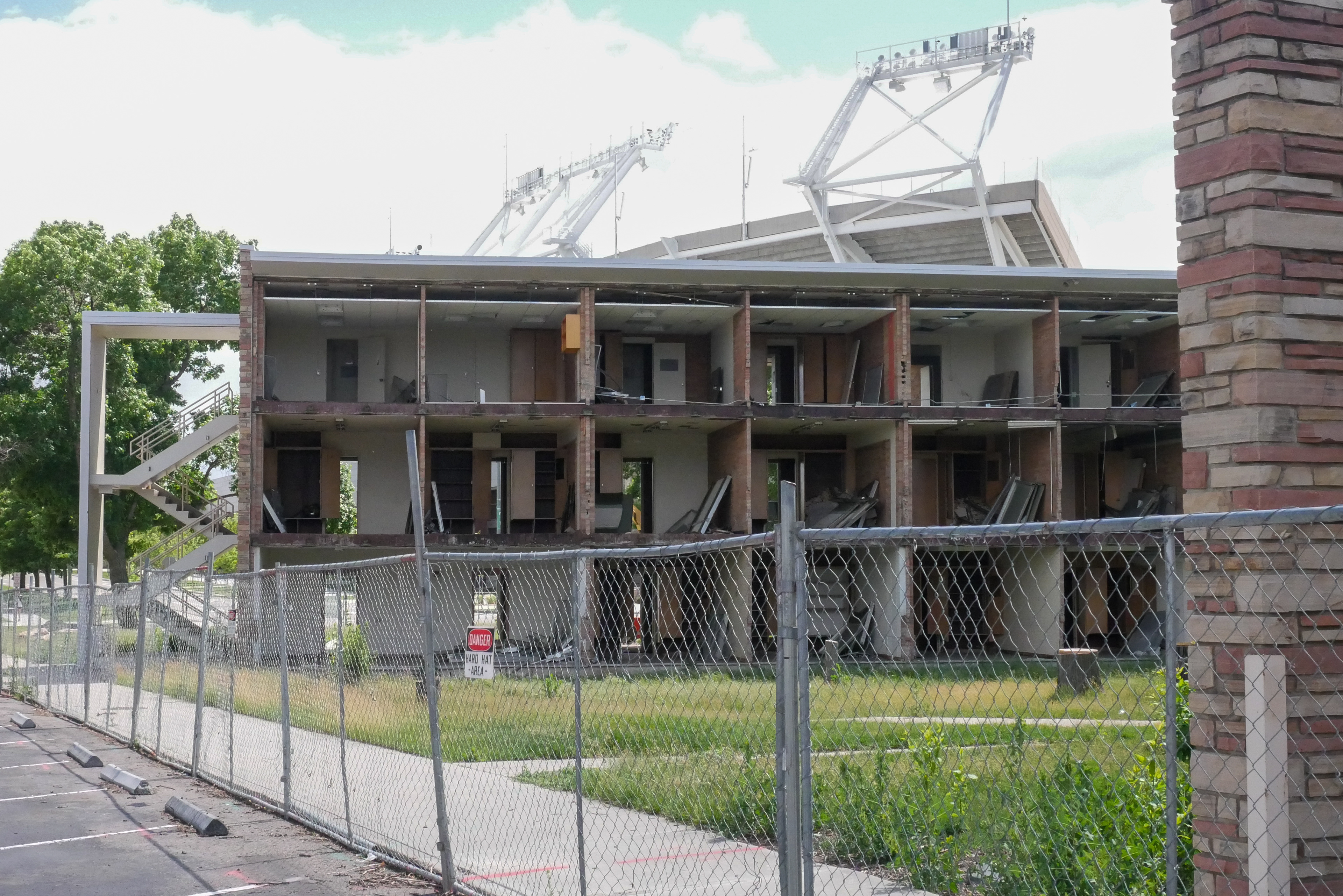 Full removal of windows and sage green panels, north-facing side of the SE wing