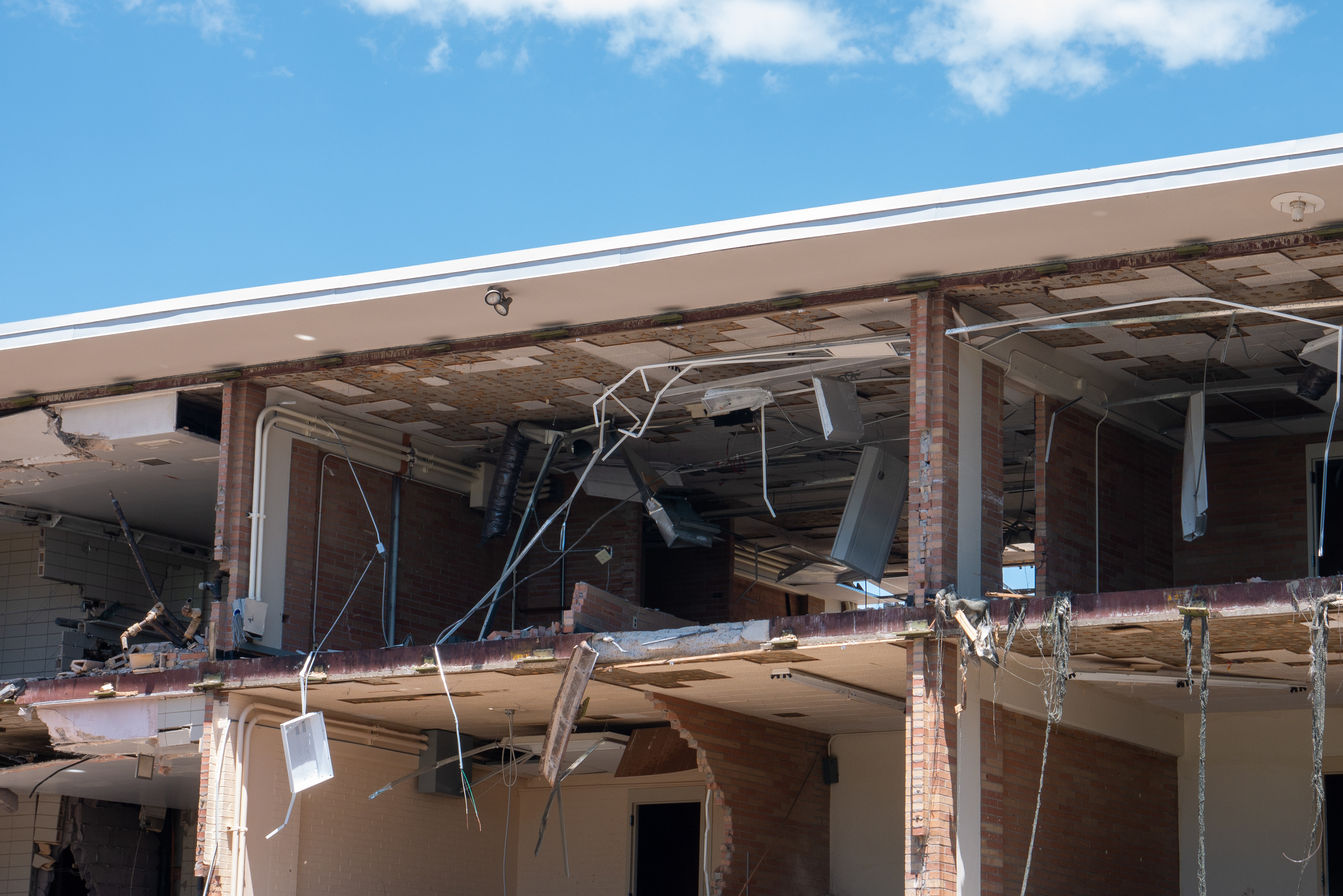 Destroyed HVAC system hanging from third floor ceiling of the SE wing, south-facing side
