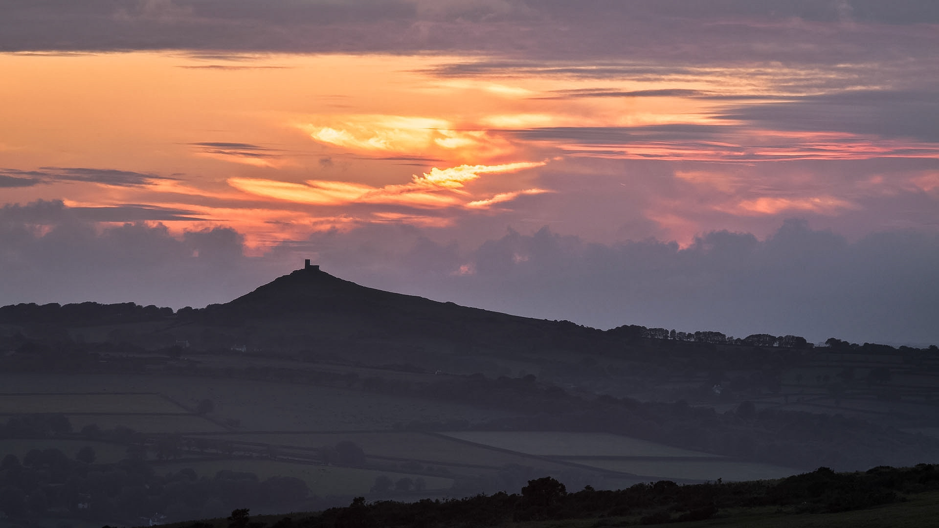 A shot of the sun setting behind Brentor, Dartmoor