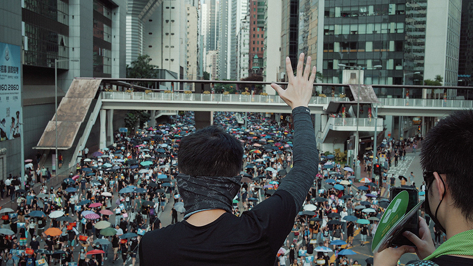 Protester displays the five-finger salute