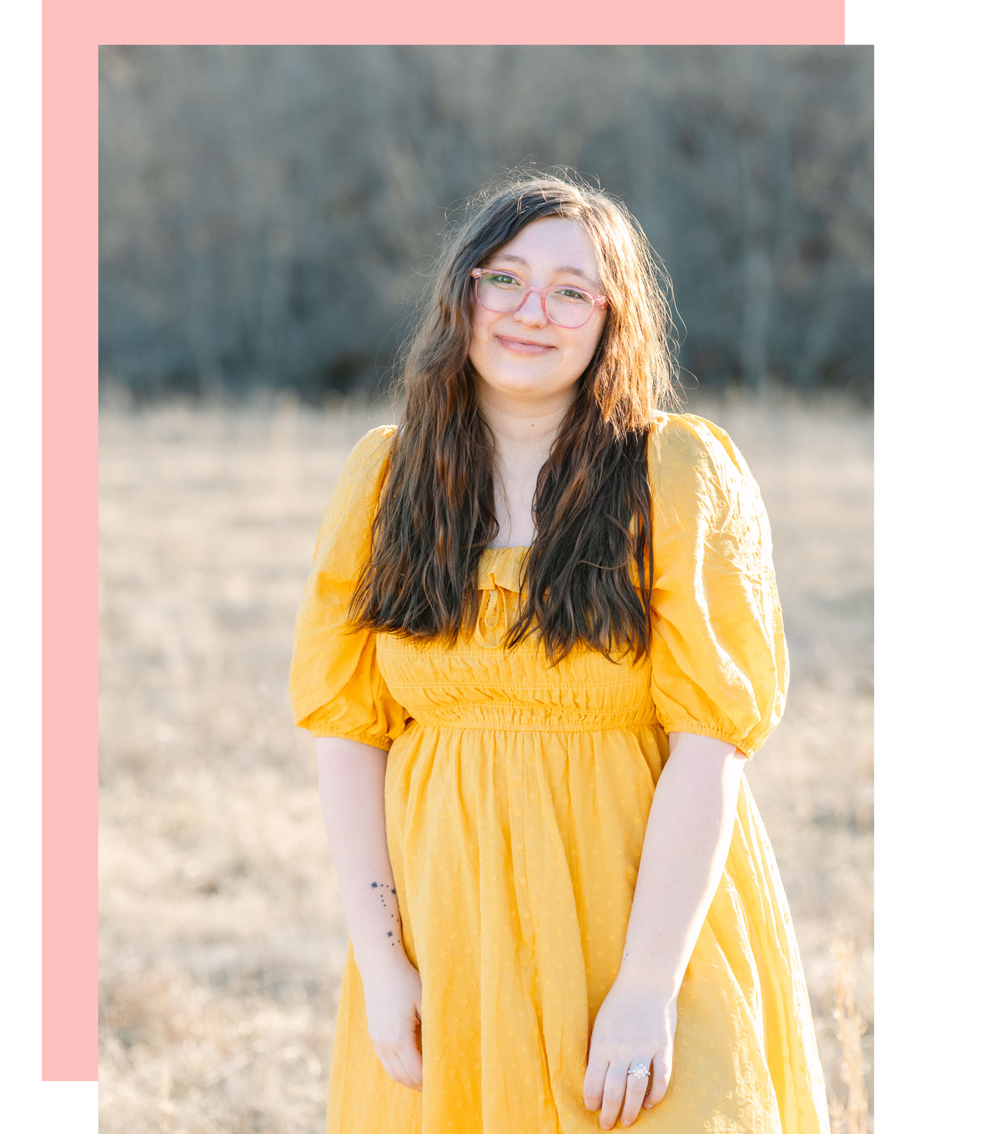 A photo of the owner of Leandra Nicole Photography smiling in a yellow dress on a family farm in Cynthiana KY