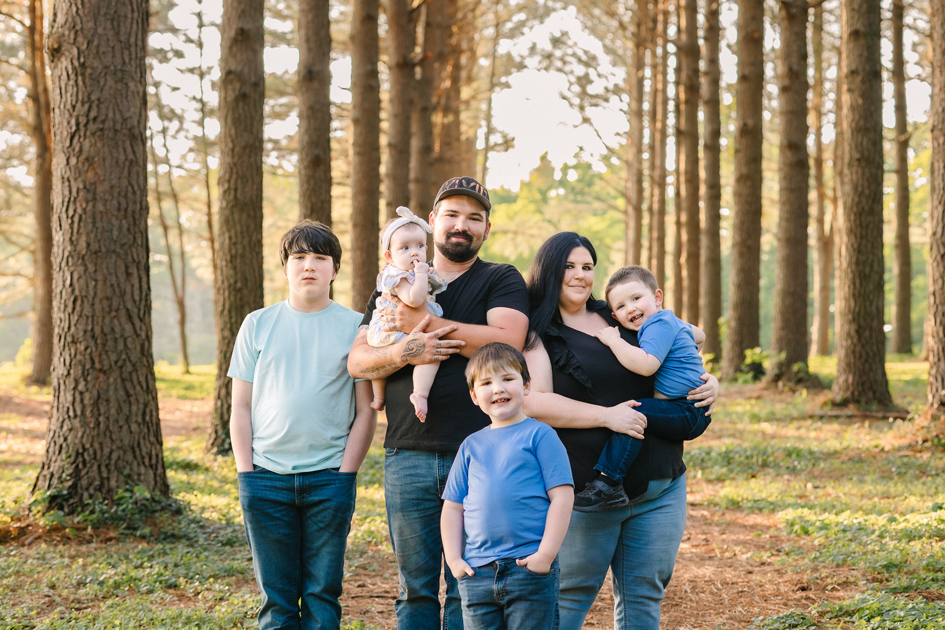 Photo of a family with 4 kids standing and smiling at Jacobson Park in Kentucky