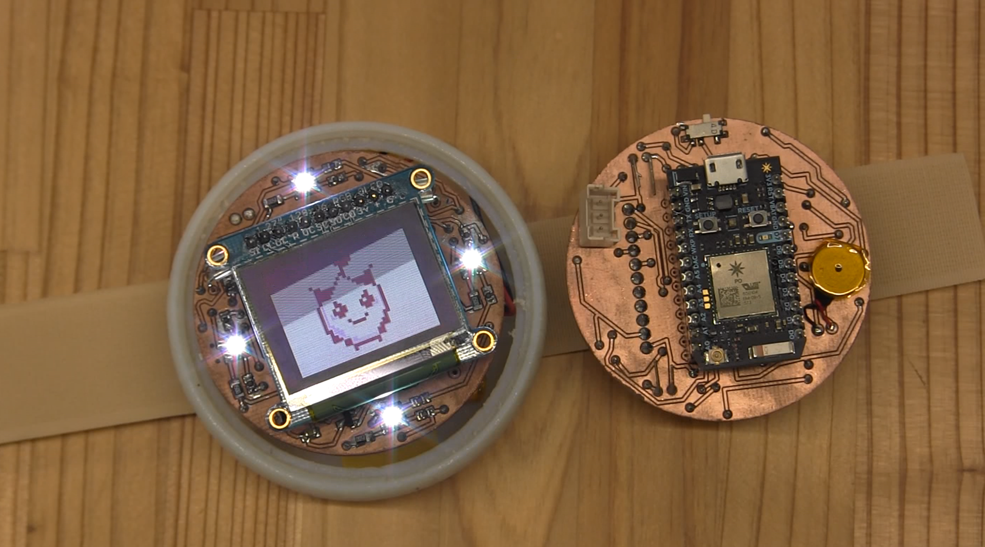 Inside Friend*Chip: The wearable integrates LED feedback, a pixel-based avatar display, and a microcontroller. It detects proximity and touch, enabling real-time interaction and pet evolution between connected users.