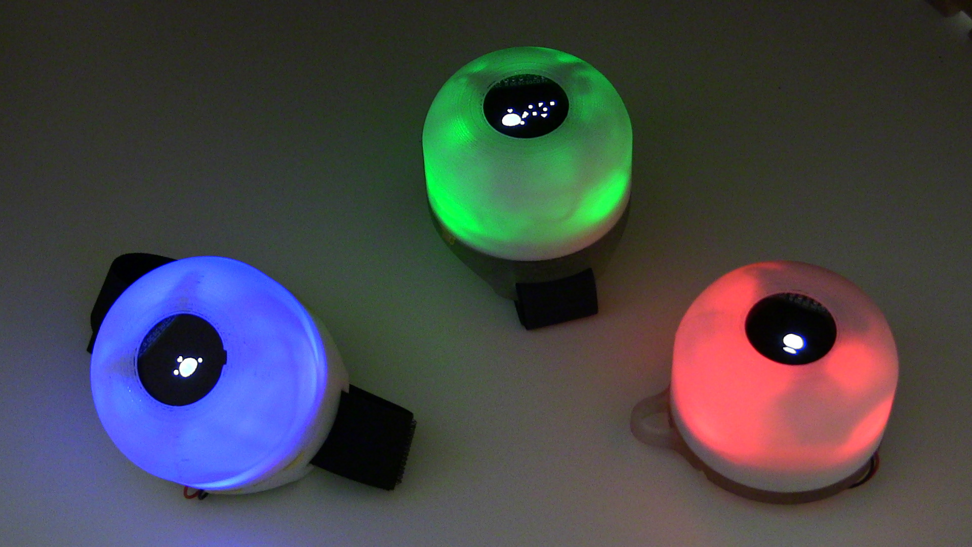 Early version of the Friend*Chip wearable digital pet. Each module glows in a specific color to indicate group affiliation. When users shake hands, their pets interact via infrared sensing—growing one step and forming social clusters with others.