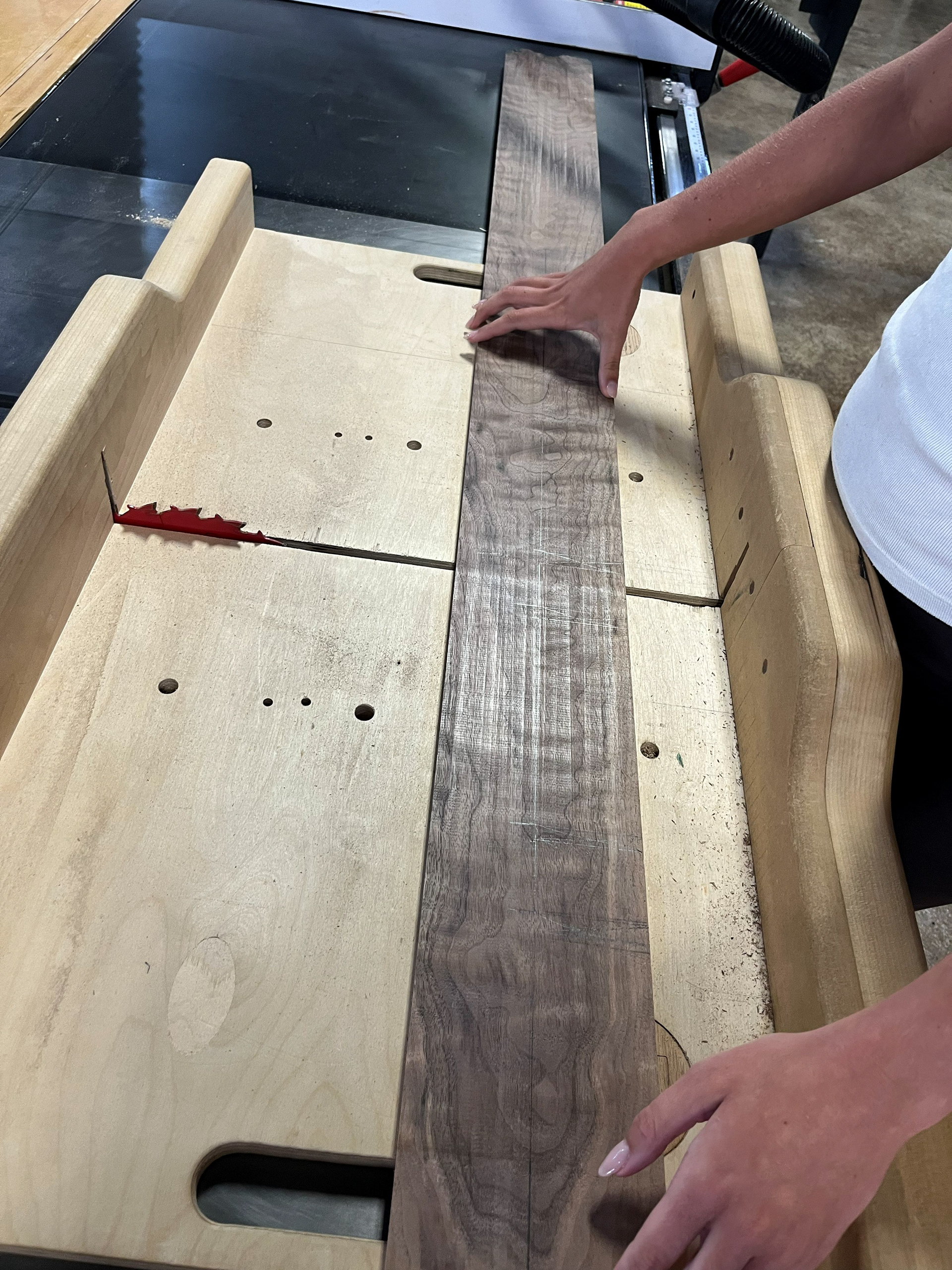 Image 8 | Cross-cutting the 4/4 Boards for the S-curve Leg Pieces for Each Group Member on the Table Saw with the Sled