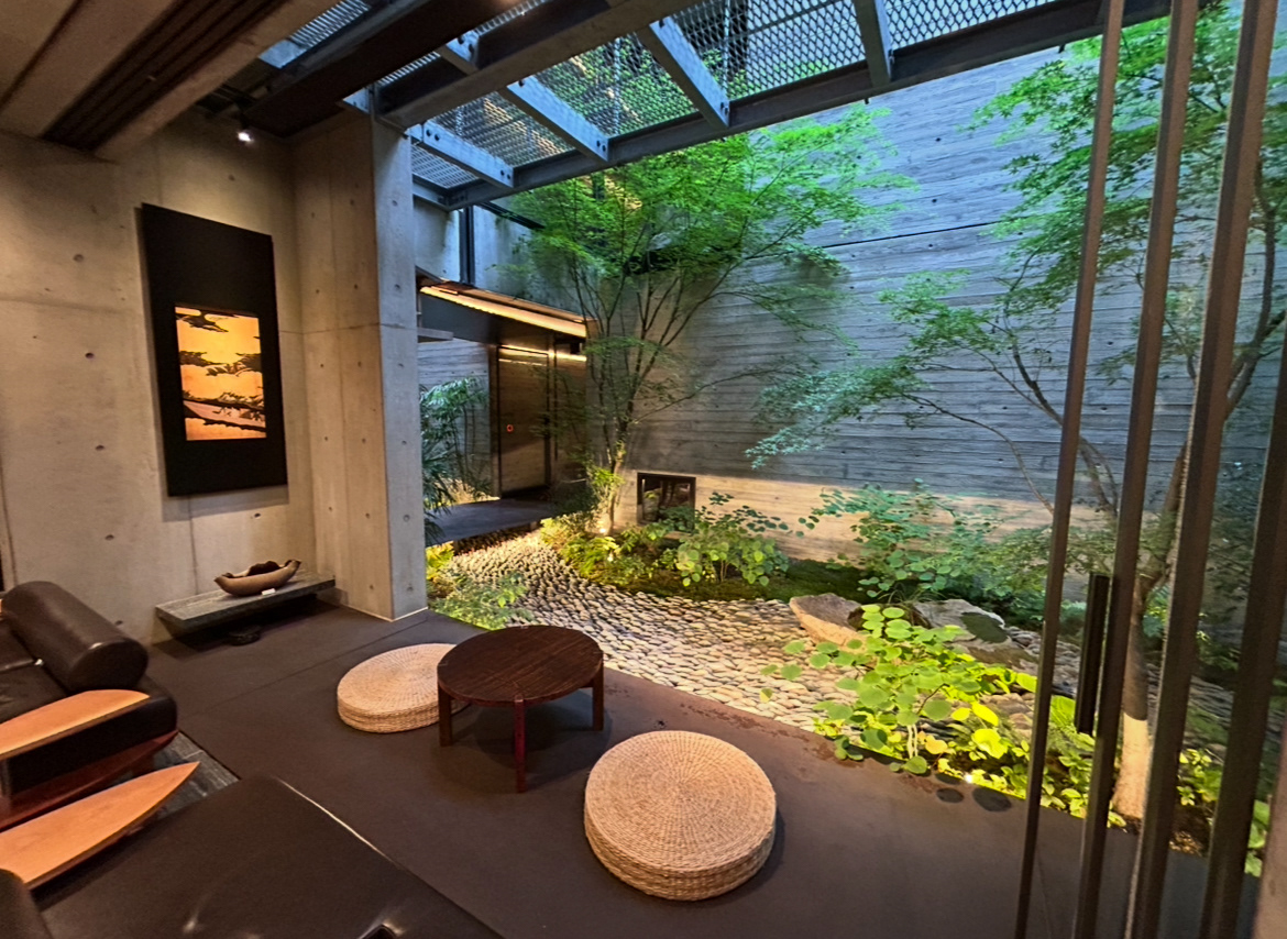 Genji Hotel seating area looking into a tsuboniwa.