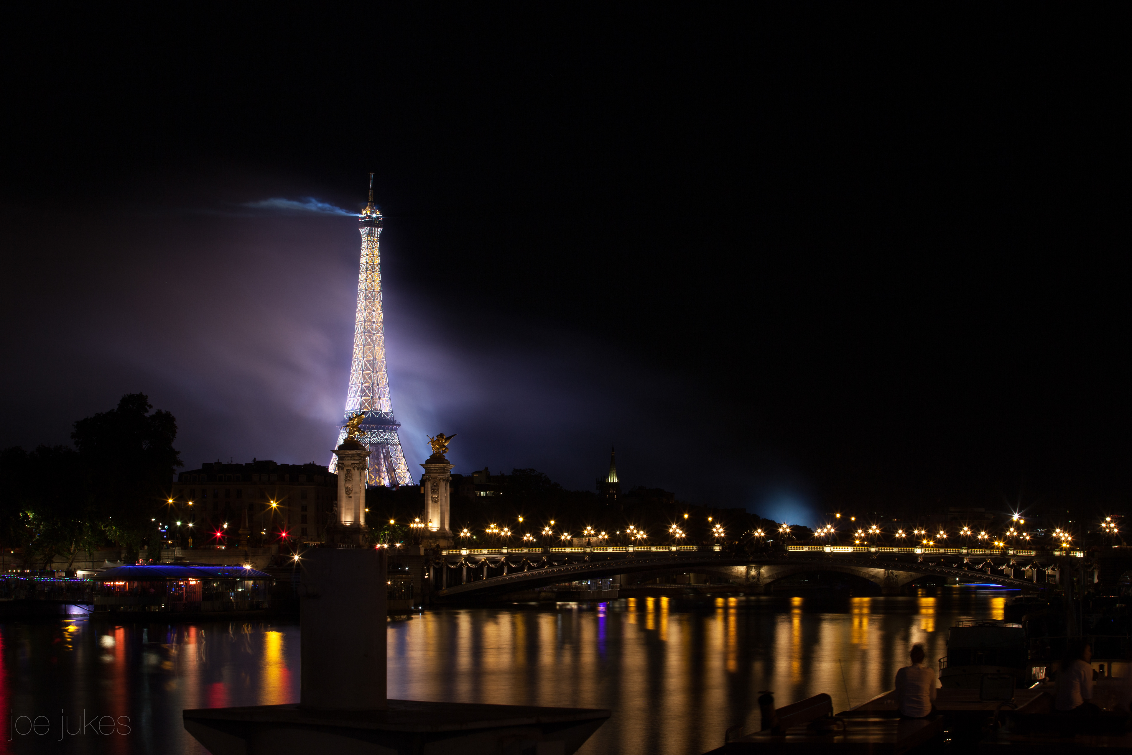 Overlooking the Eiffle Tower and pont Alexandre III from the banks of the River Seine, fireworks on Bastille Day, 14th July - Paris, France