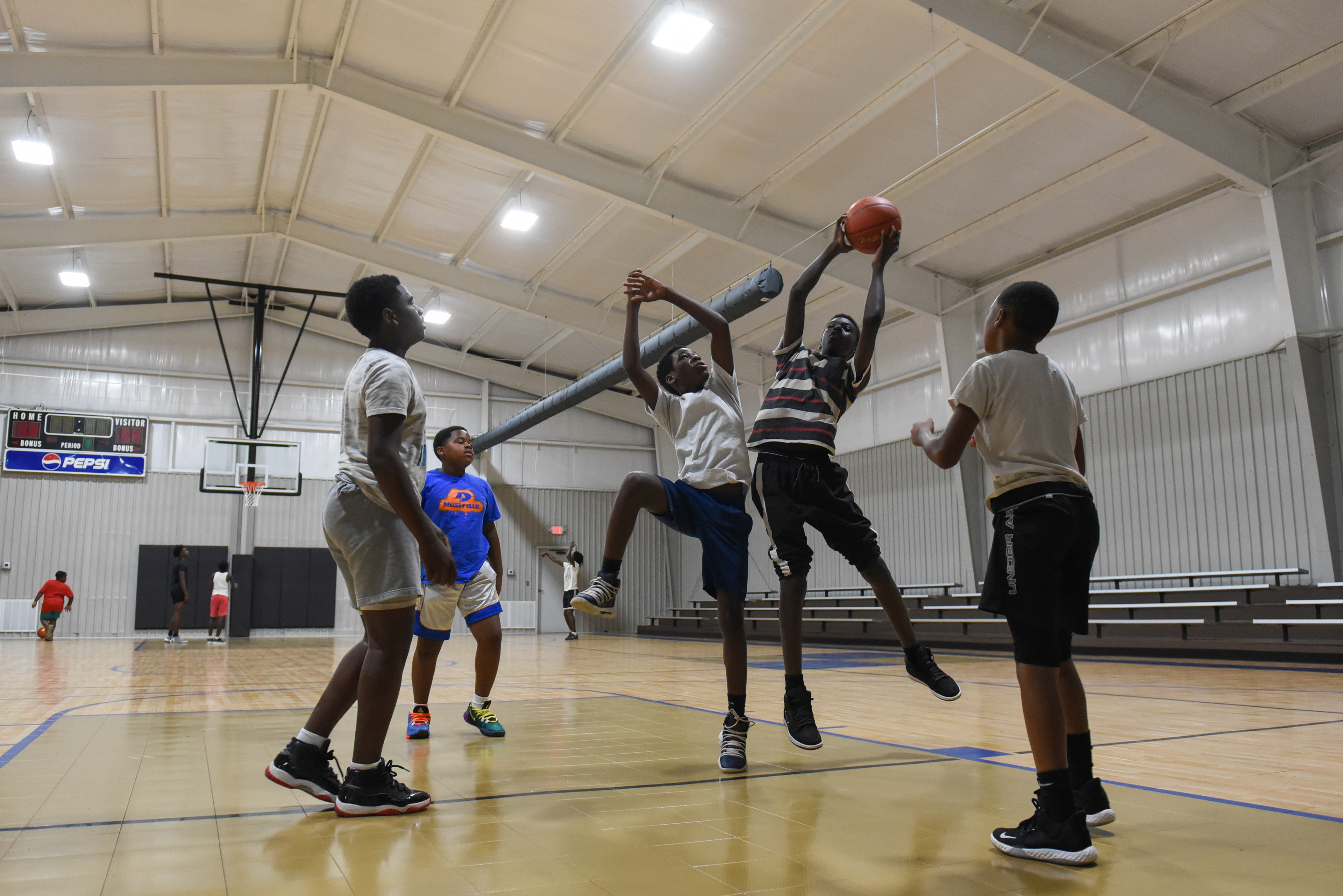 A group of friends plays basketball on Thursday at the Crawford Community Center. The boys came from Crawford, Artesia and Starkville to play on the new court, which finally reopened after it was destroyed in a tornado in February 2019.