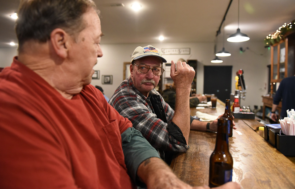 From left, Jim Tapp looks at Wayne Hoener as the two drink beer at the bar Friday, December 6, 2019 at The Corner in Rhineland, Missouri. The following morning, Tapp would play the role of Santa Claus and visit with the children in town. Tapp has been the town Santa for the last twenty years.
