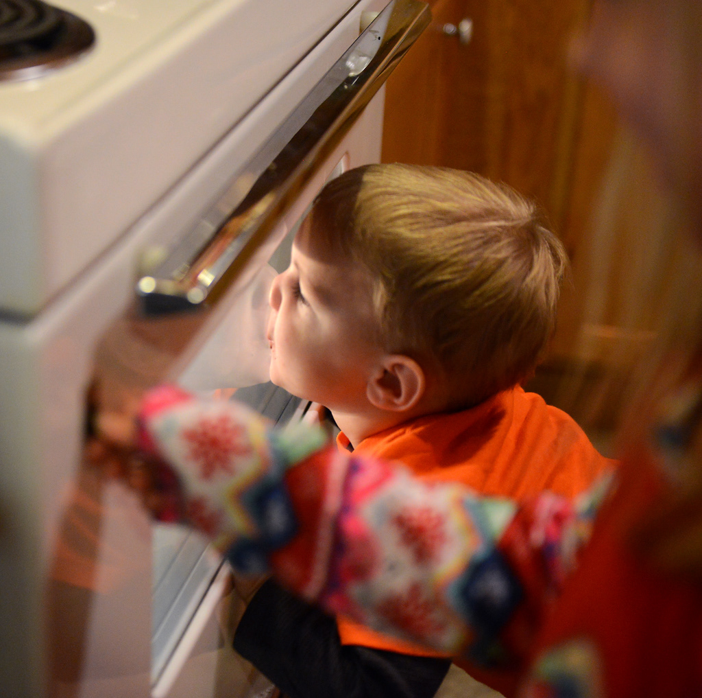 Benton Panhorst, 2, makes faces on the oven door while his cousin Karena Noltensmeyer, 5, plays with the oven light during deer camp Friday, November 15, 2019 in Rhineland, Missouri. While the adults talked, Benton followed his big cousin around as the two played with cars and explored The Shack.