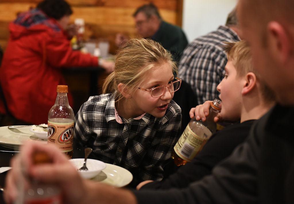 Corynn Kuebler, 9, and her brother Connor Kuebler, 11, laugh and drink cream soda during dinner at The Corner Friday, December 6, 2019 in Rhineland, Missouri. Connor, Corynn and their younger brother Bennett each picked out a soda from the vending machine at The Corner before they sat down to eat with their parents and grandparents.