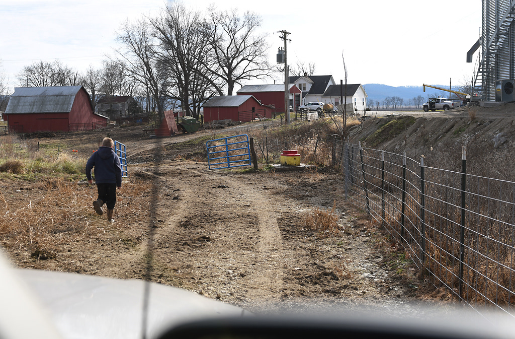 Tate Wehrle, 10, runs to open a gate so his grandfather can drive his truck through it Sunday, December 8, 2019 in Rhineland, Missouri. When asked what he wants to be when he grows up, Tate said he didn’t know. “We’re trying to talk him out of farming,” his grandfather said in response because he said it’s hard to make a living as a farmer nowadays.