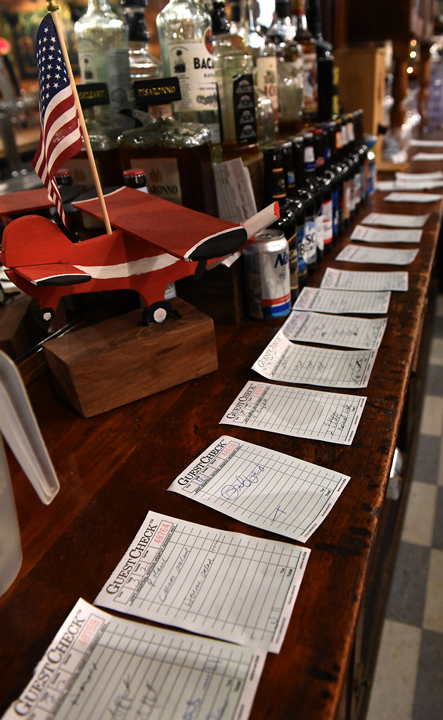 Tickets with each tables’ order line the back of the bar Friday, December 6, 2019 at The Corner in Rhineland, Missouri. The Corner also has a reception hall connected to it for town gatherings, like when Santa comes to visit the children in town.