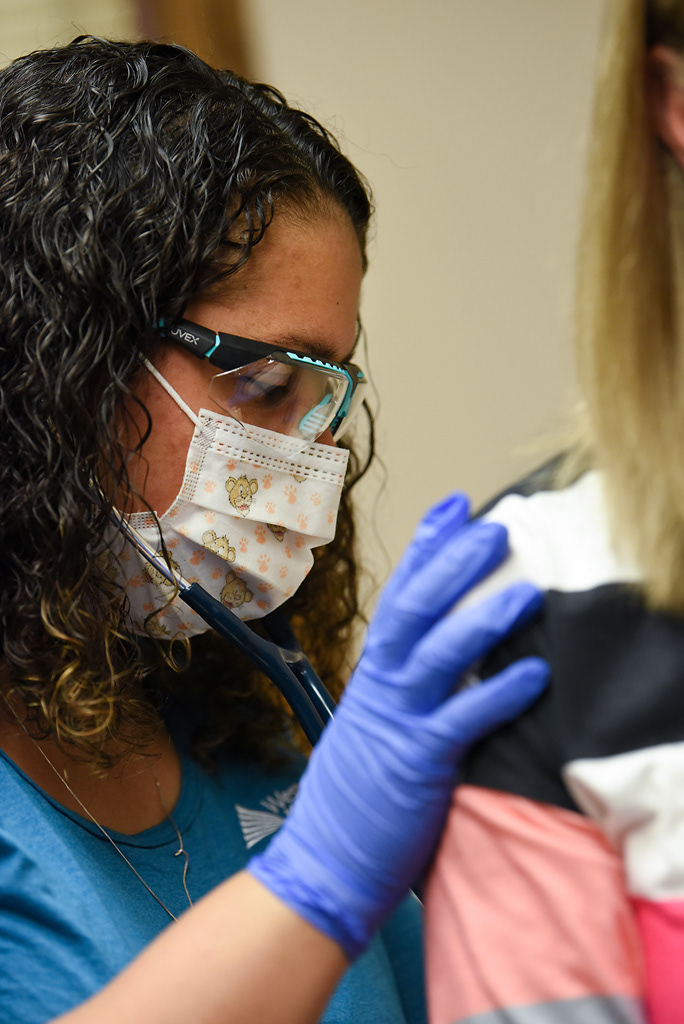 Sarah Kirchhoff presses her stethoscope into Jana Mueller’s back to listen to her lungs during a routine physical on Tuesday, April 28, 2020 at the Western Missouri Family Healthcare clinic in Concordia. Since the state shut down, Kirchhoff has been seeing six to eight patients a day, whether that be in-person, virtually, or over the phone. Before COVID-19, Kirchhoff said she saw 12 to 15 patients a day. Despite these slower days, Kirchhoff said she’s grateful for the support of the hospital system and the entire community. “You're really seeing people pull together and asking people if they need anything,” Kirchhoff said.