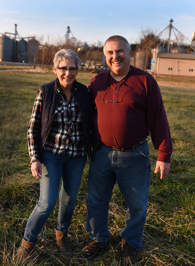 From left, Kim and Ronnie Stiers pose for a portrait on the plot of land where their home used to be located before the town relocated uphill Friday, December 6, 2019 in Rhineland, Missouri. The Stiers moved their home in three stages.