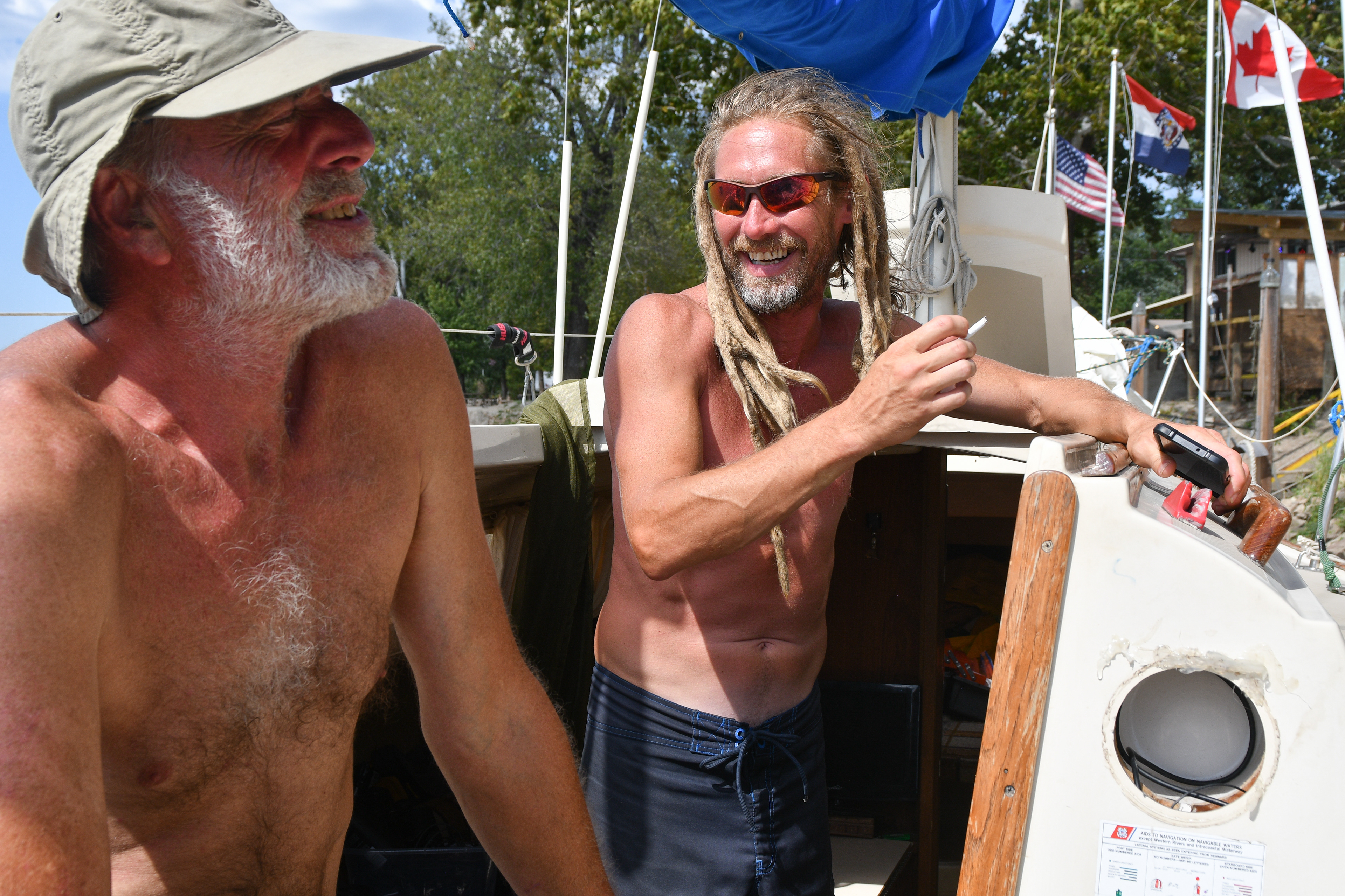 From left to right, Kyle McCreary and Justin Maguire laugh together aboard Jane Dancer on Friday, September 27, 2019 at Cooper's Landing in Columbia. McCreary and Maguire have known each other for 25 years. Mcreary, the boat's skipper, has been sailing for 20 years. Maguire, his first mate, has been sailing for two months.