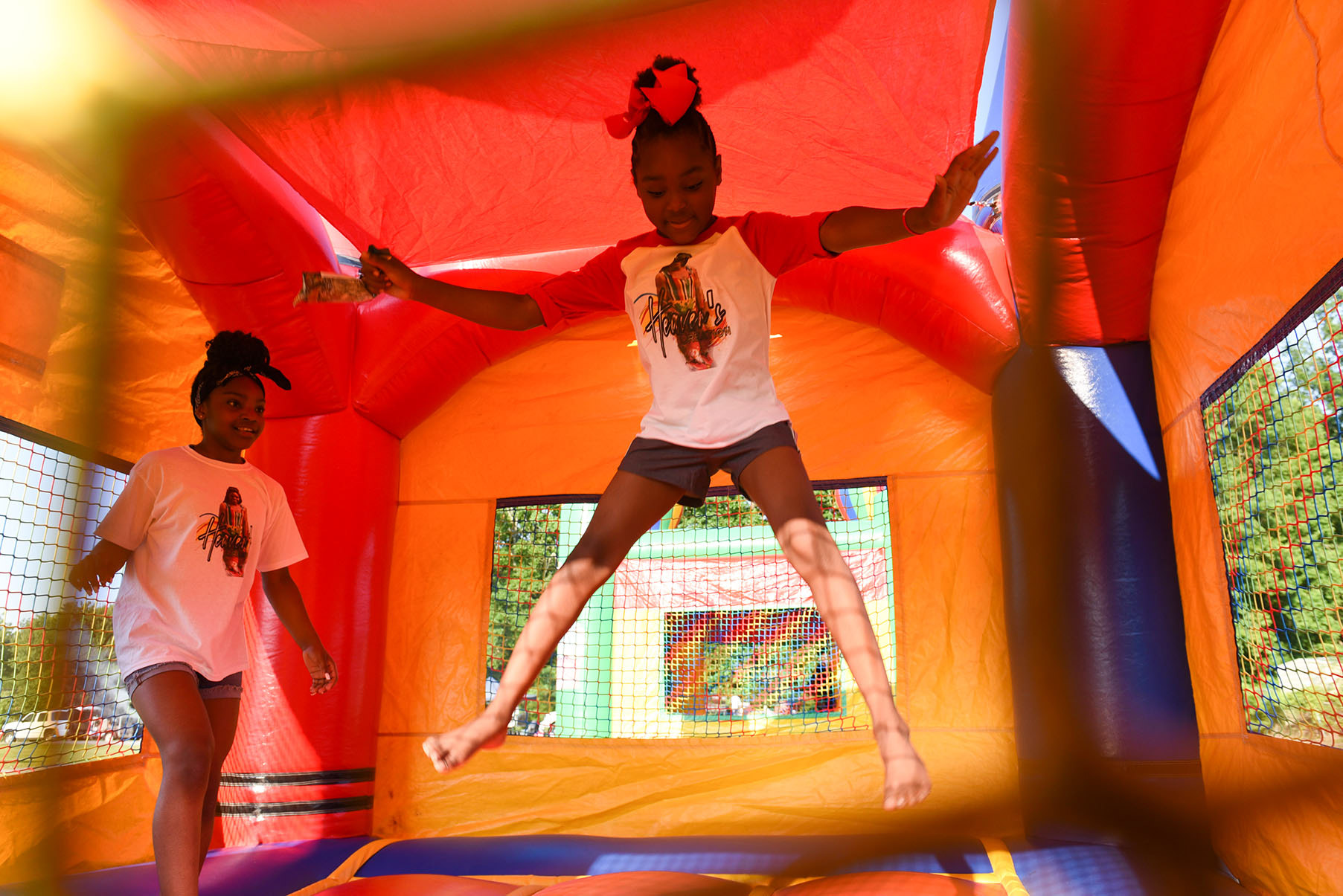Aaniyah Cole, 8, jumps up in the air while her cousin Kelvyianna Jackson, 11, watches on Friday during a Juneteenth celebration at Southside Park in Columbus. Aaniyah and Kelvyianna are from Jackson, Tennessee and came to Columbus to celebrate Juneteenth with their grandpa, who lives in town. 