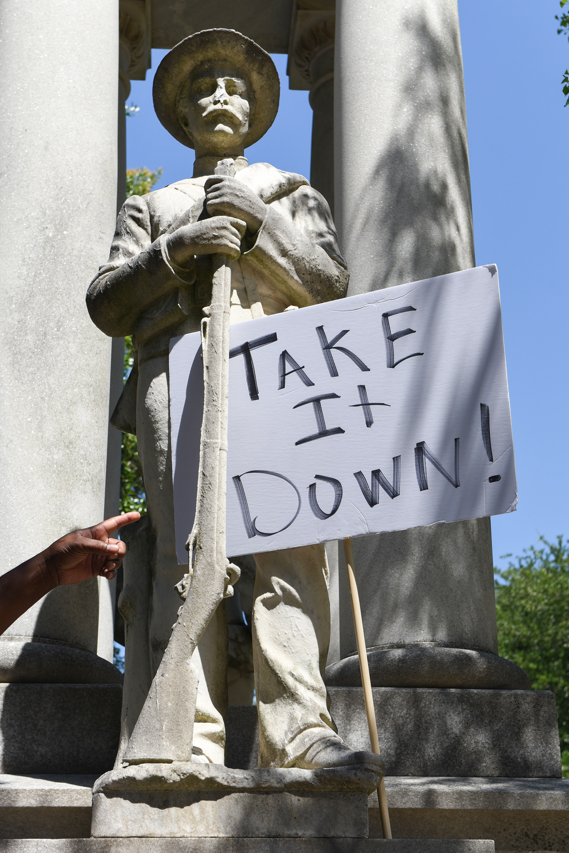 Flex Little points to a sign posted on a Confederate monument that reads “Take it down!” during a protest demanding Lowndes County Board of Supervisors President Harry Sanders’ resignation on Wednesday, June 17 on the Lowndes County Courthouse lawn. Both District 41 Rep. Kabir Karriem and District 5 Supervisor Leroy Brooks said during the protest that Sanders has exhibited “bigotry and elitism” throughout his term.