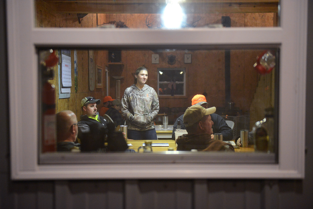 Brenna Panhorst listens to someone share a story during deer camp Friday, November 15, 2019 in Rhineland, Missouri. The Bruckerhoff family gathered in The Shack on their land for a family tradition of sharing a meal together to celebrate the opening weekend of deer hunting season.