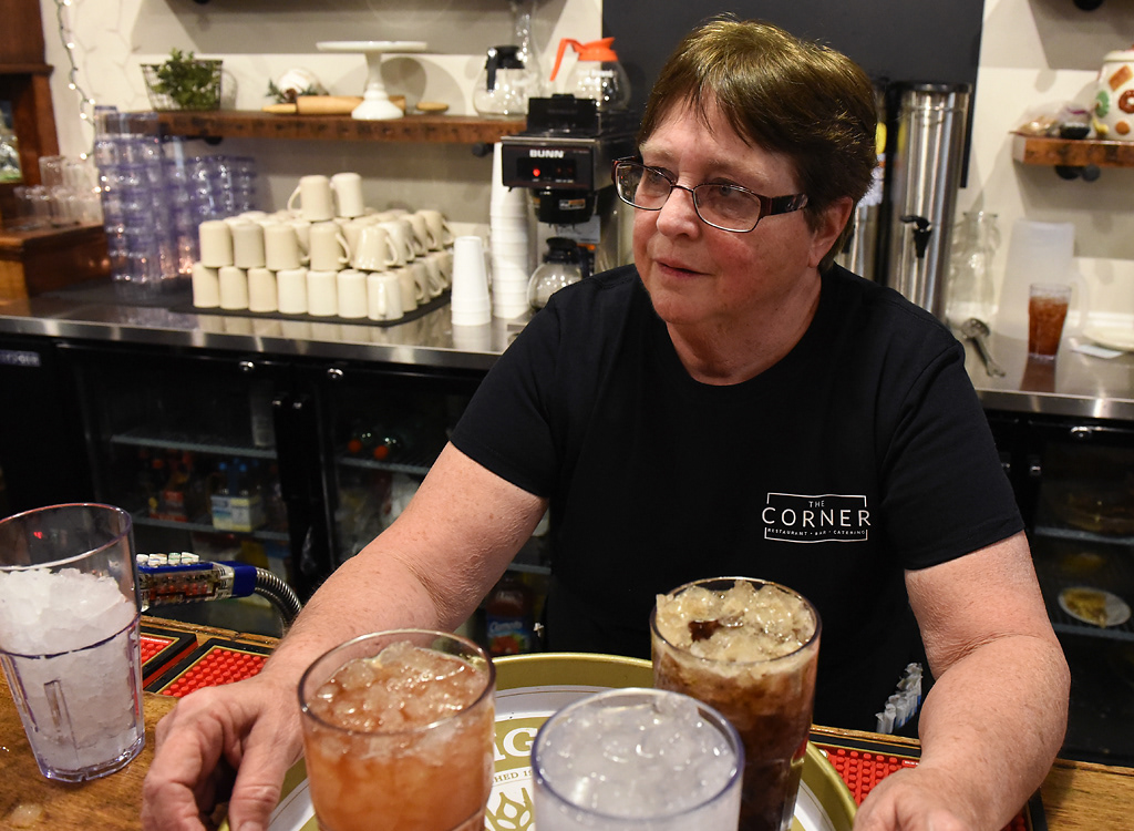 Janet Wehrle picks up a tray of drinks Friday, December 6, 2019 at The Corner in Rhineland, Missouri. Wehrle also works at the bank in town. She picks up shifts at the tavern when they’re short-staffed or know they’re going to be busy.