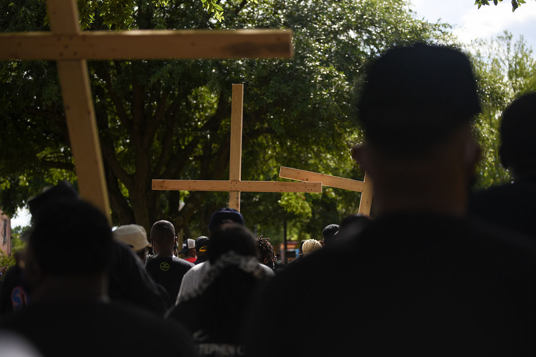 Protesters arrive at the Lowndes County Courthouse during the Jesus and Justice Rally on Sunday, June 7, 2020 in Columbus. Community leaders marched at the front of the group and carried three wooden crosses during the march. They took turns carrying the crosses to symbolize sharing the burden of racism and sharing the fight against it.
