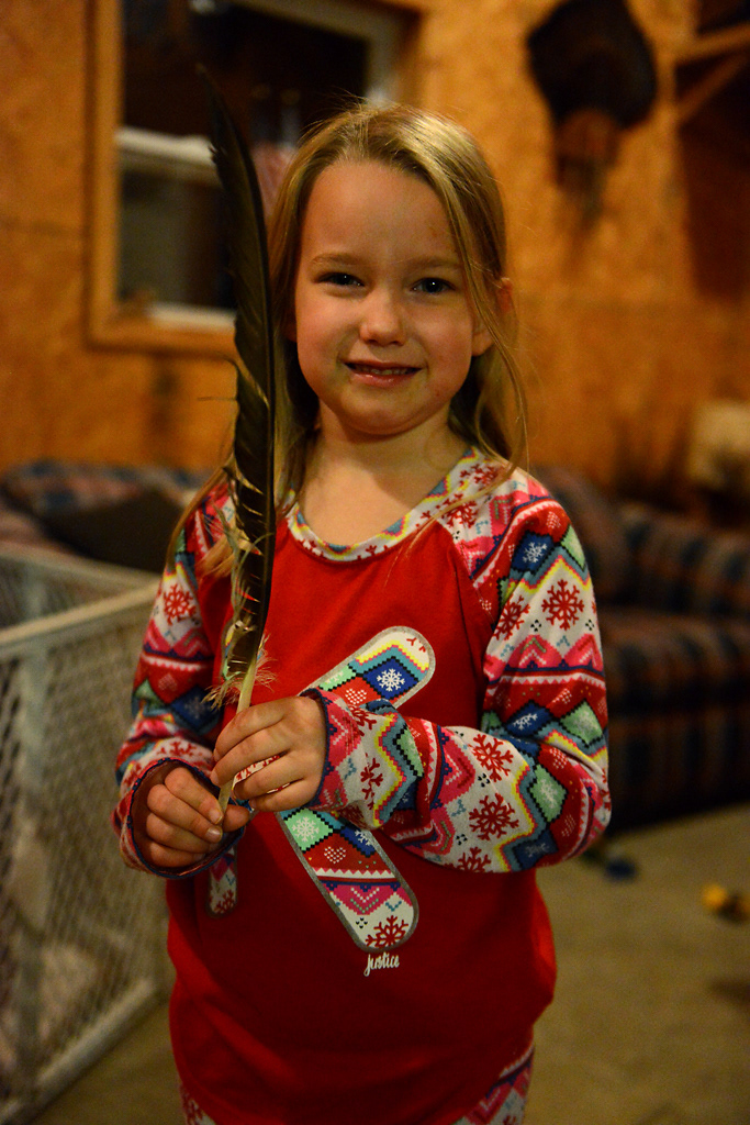 Karena Noltensmeyer, 5, poses for a portrait during deer camp Friday, November 15, 2019 in Rhineland, Missouri. Noltensmeyer found a feather lying around The Shack and used it as a toy for the rest of the night.