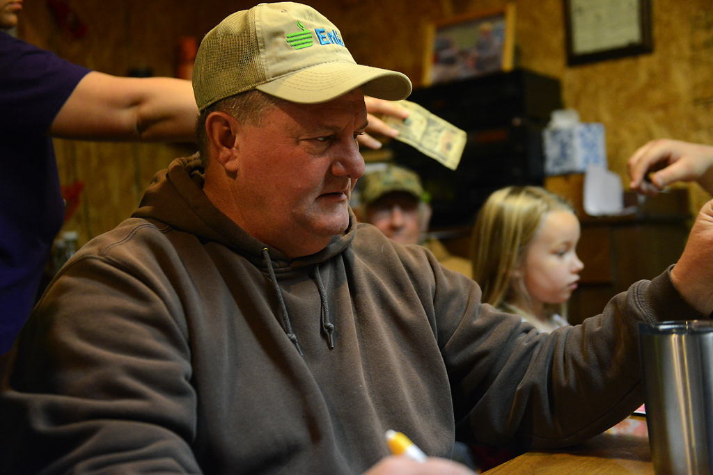 Curtis Bruckerhoff collects money for the deer camp pool Friday, November 15, 2019 in Rhineland, Missouri. The person with the most points at the end of the weekend wins the pool of money.