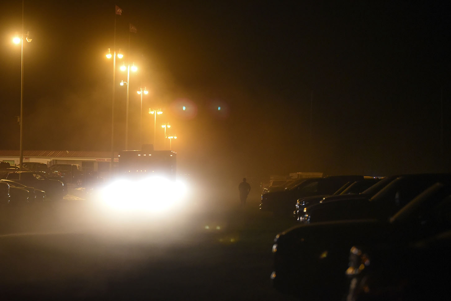 A man walks through a cloud of dust in the parking lot on June 6 outside Magnolia Motor Speedway in Columbus. The next event at The Mag is the United Sprint Car Series on July 4.