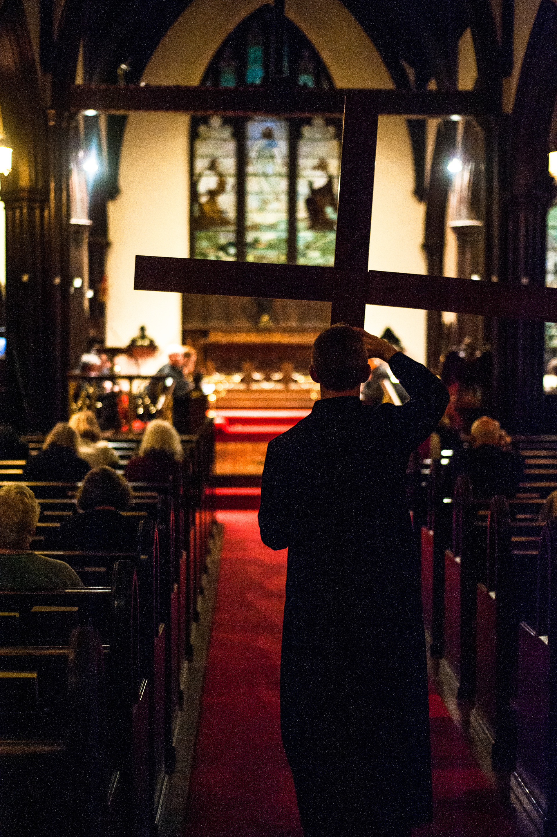 Zachary Borgstrom carries a bare cross towards the altar during a Good Friday worship service at Saint James’ Episcopal Church // MARCH 30, 2018, WARRENTON, VIRGINIA // FOR SAINT JAMES' EPISCOPAL CHURCH