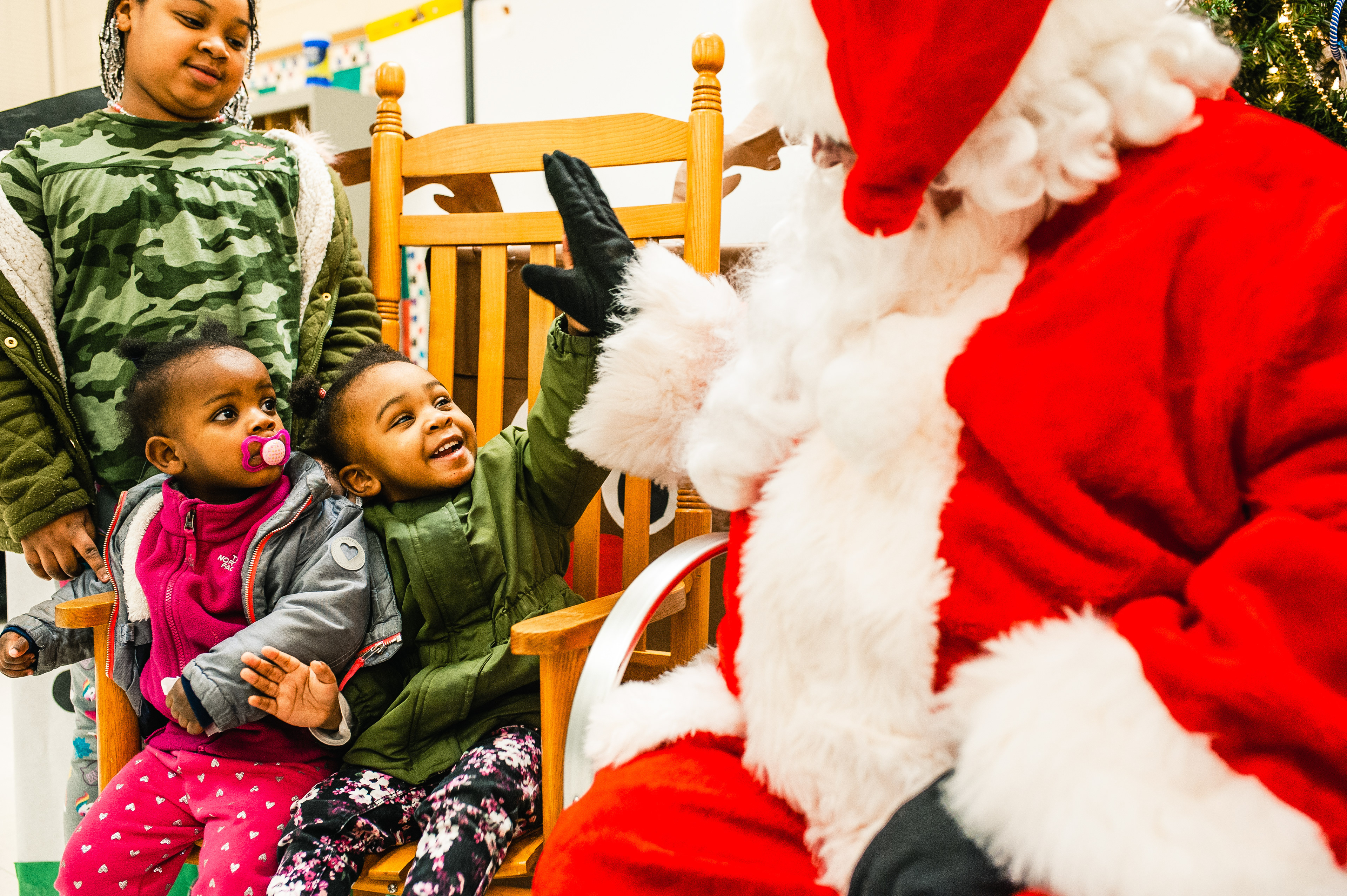 A child high-fives Santa Claus at a Christmas program held at Warrenton Community Center for Fauquier County Head Start students // DECEMBER 18, 2018, WARRENTON, VIRGINIA // FOR THE FAUQUIER TIMES