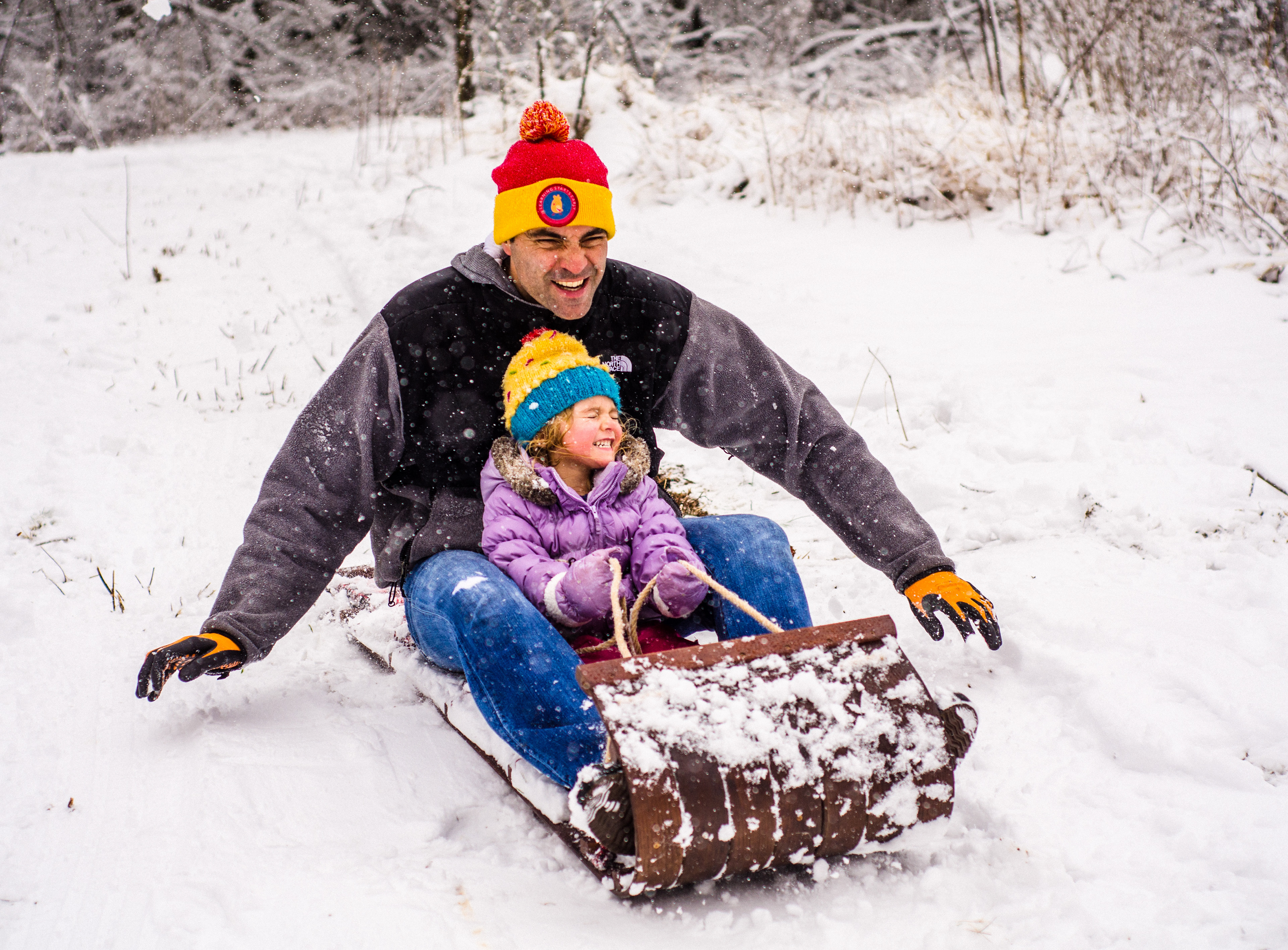 Mike and Ella sledding in their backyard.