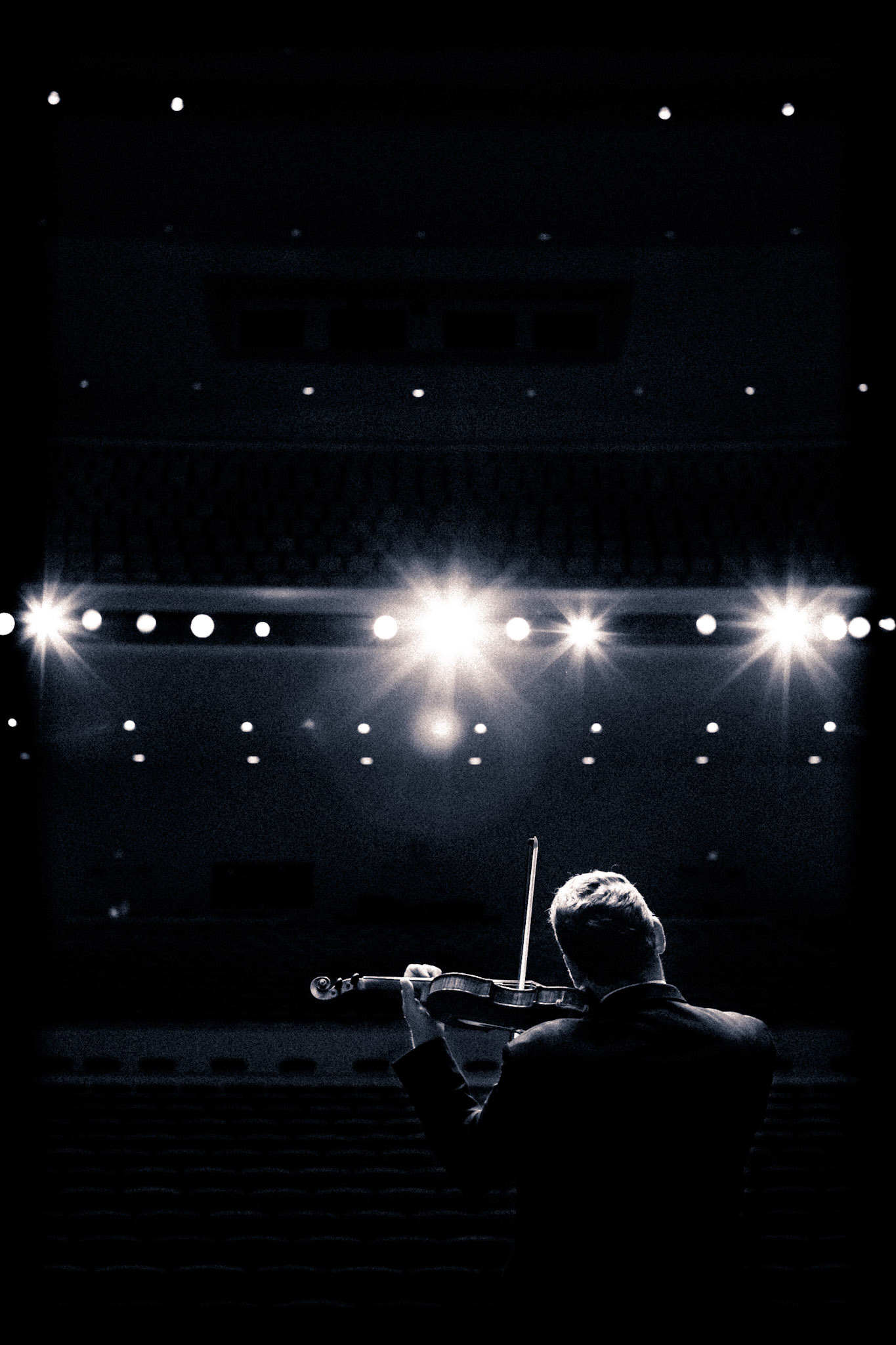 Violinist on stage with full dramatic lighting at the Phoenix Symphony Hall