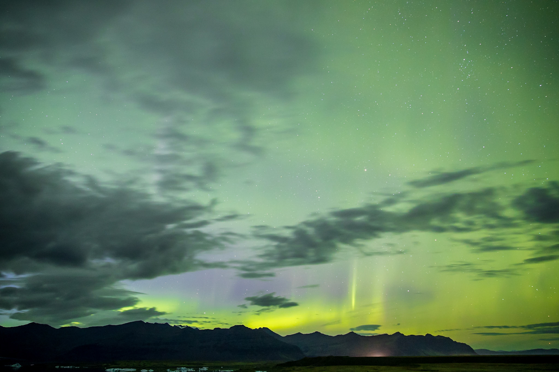 Sometime after the sun dropped in Iceland, someone in the area started yelling, look at the sky. There was a strange, glowing cloud wiggling its way through the sky. I had no idea it was the Northern Lights. Until I took a photo of it. Then it lit up green and purple. I knew what I was seeing.
