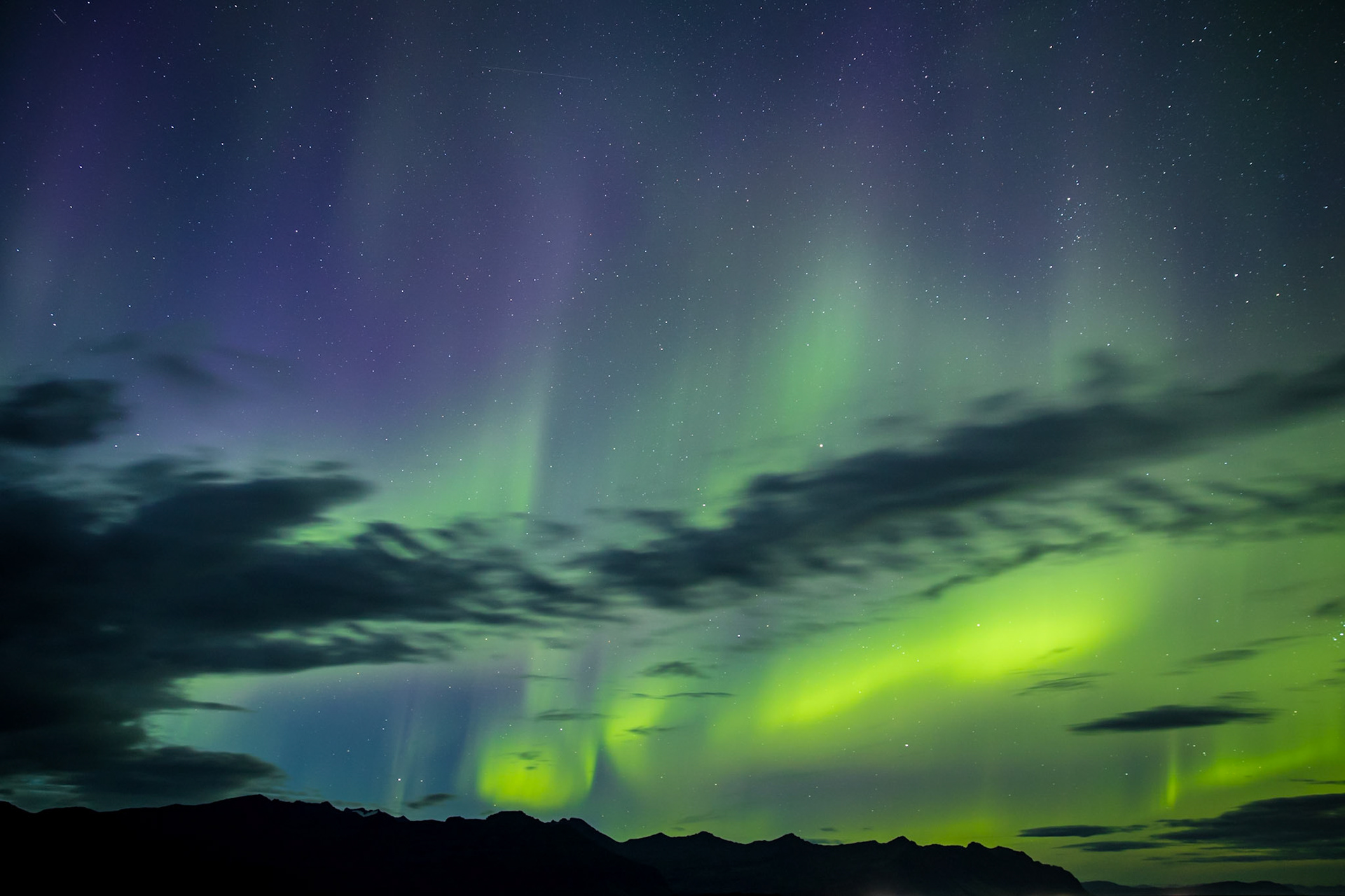 Sometime after the sun dropped in Iceland, someone in the area started yelling, look at the sky.  There was a strange, glowing cloud wiggling its way through the sky.  I had no idea it was the Northern Lights.  Until I took a photo of it.  Then it lit up green and purple.  I knew what I was seeing.