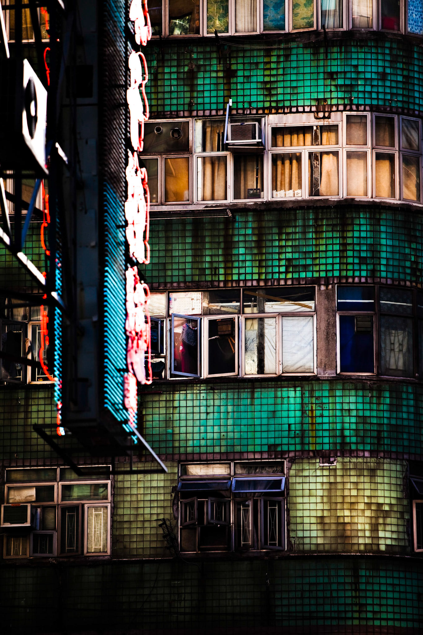 Hong Kong, China.  Street signs in down town Hong Kong crowd the space between the buildings.  The signs are a mixture of western and eastern influenced and show the diversity of culture and language in the busy city.