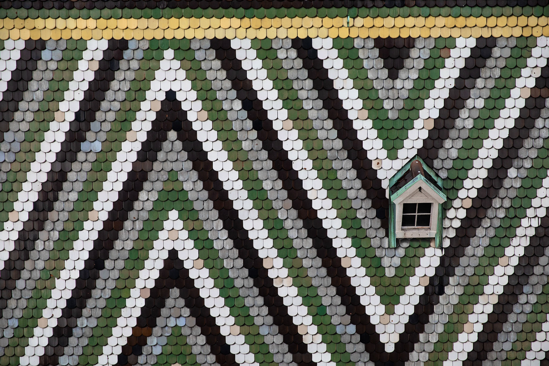 From the very top of the Cathedral of St. Stephan in Vienna, which is a very long climb, you not only get a lovely view of the city, but of the beautiful shingle work on the roof.  I love the graphic design on this rooftop and enjoy letting my eyes wander around catching the discolored shingles.  Isn't that the natural yearning of the human mind, to look at a pattern and then to stick on the anomalies in that pattern.  The real trick to being a better human is not to ignore the differences in the pattern, but to see them and appreciate how useful they are to the overall composition of the whole.  And yes, even the big interruptions in the pattern are valuable to the composition.  Don't destroy the rooftop because the green shingles are not all the correct color of green, or because some of the grey shingles kept too much of their original blue.  The rooftop is beautiful because of the harmony and the imperfections.@canonusa @tethertools @triplescoopmusic @shootdotedit #Vienna #austria #travelphotography # architecturalPhotography #lifeLessons @atlaspacks #learnphotography