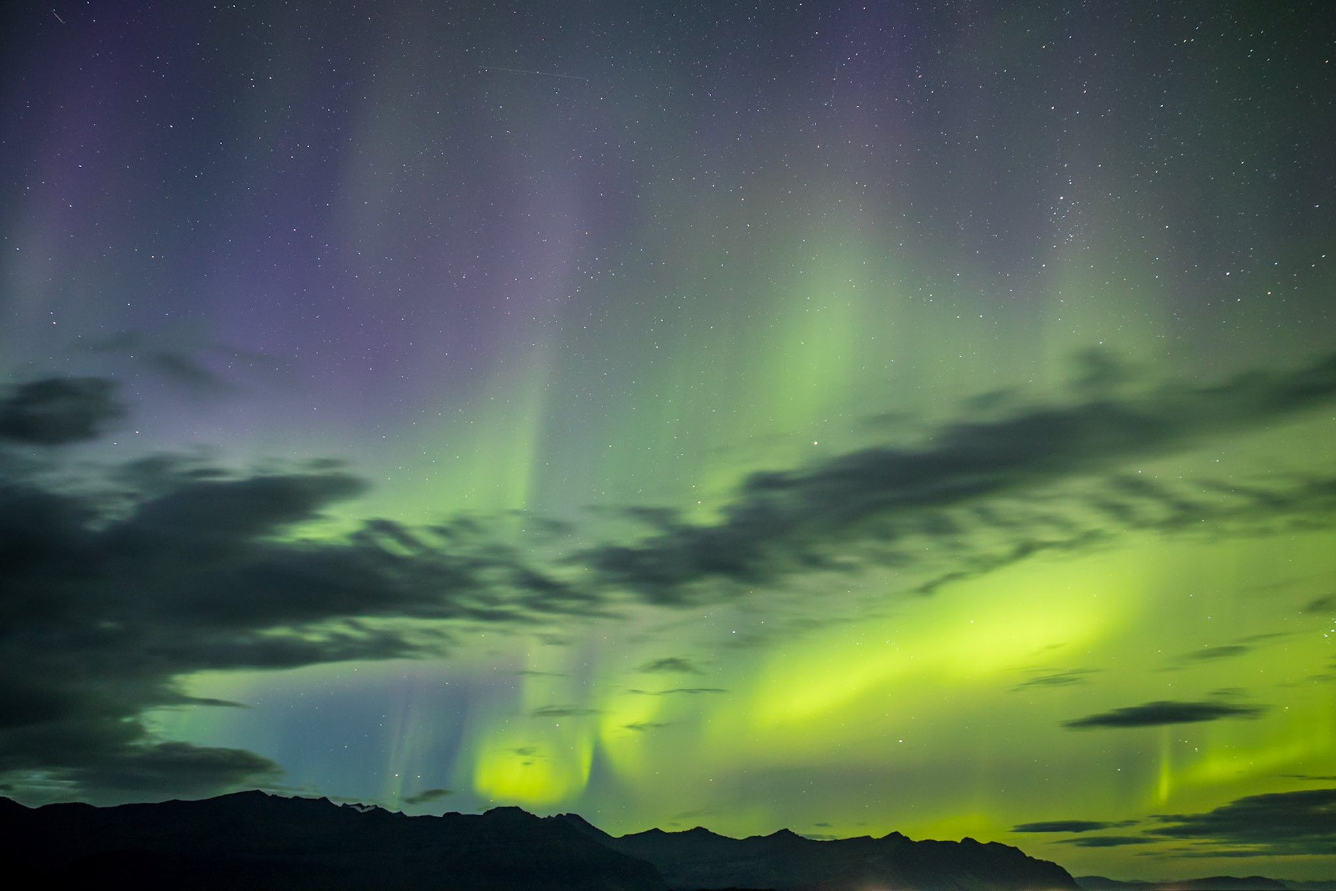 Sometime after the sun dropped in Iceland, someone in the area started yelling, look at the sky.  There was a strange, glowing cloud wiggling its way through the sky.  I had no idea it was the Northern Lights.  Until I took a photo of it.  Then it lit up green and purple.  I knew what I was seeing.