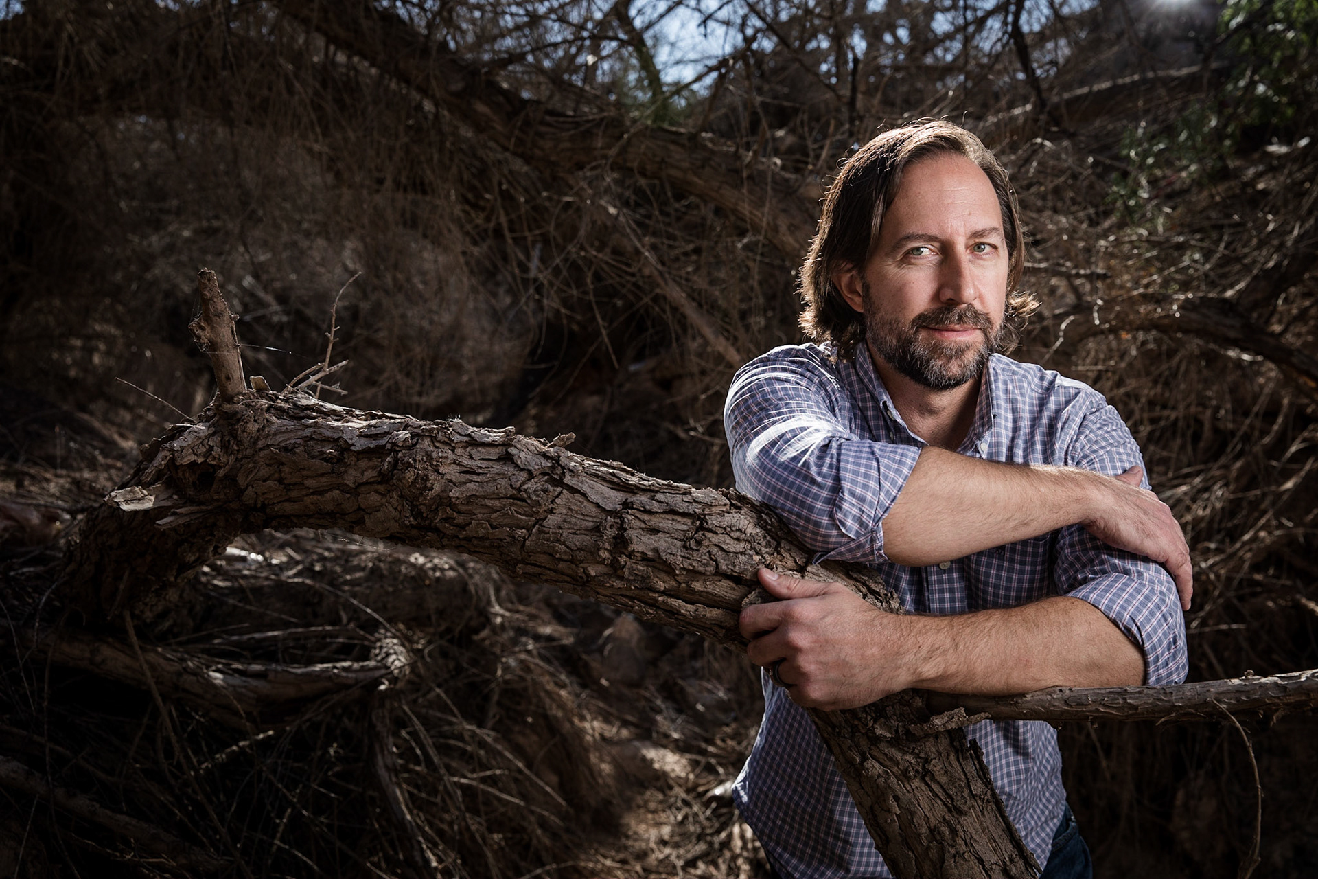 Profoto lighting demonstration of the Profoto B10 with a 2x3 Softbox with Soft Grid and two Profoto A1 flashes as back lights for the trees and subject.  The left A1 is at a power of 7.5 and the right A1 is at a power of 10.  The B10 is at a power of 7-9 depending on how close the subject is to the light.