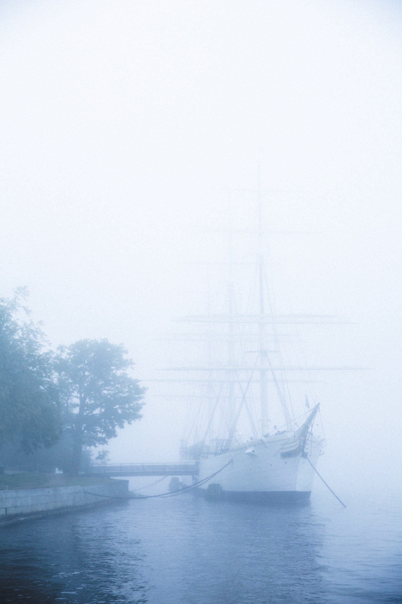 Historic sailing ship docked in the fog in Stockholm Sweden.  This boat is now used as a hostle for travelers.