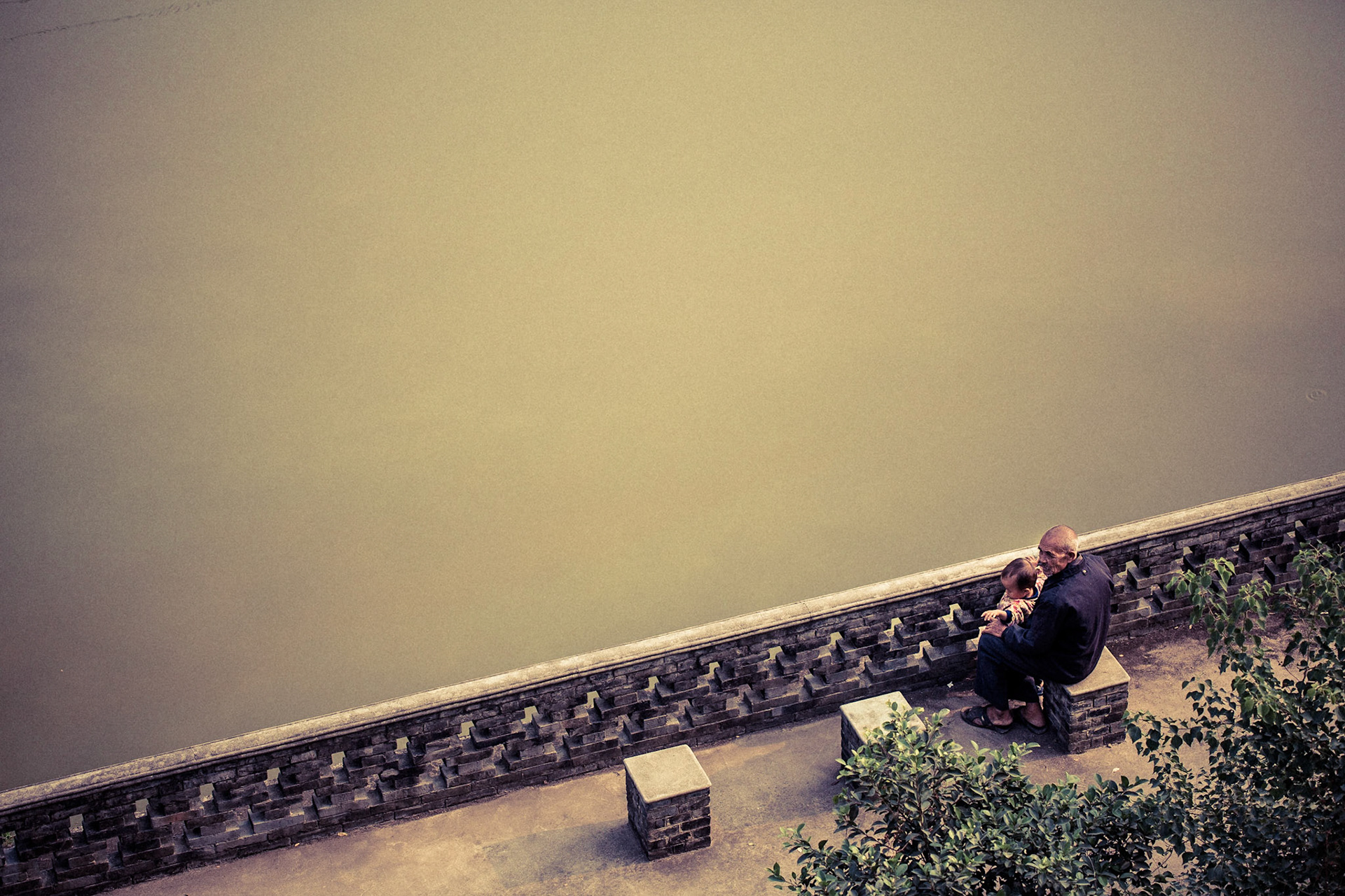 A grandfather tends to his grandson in Guilin China.