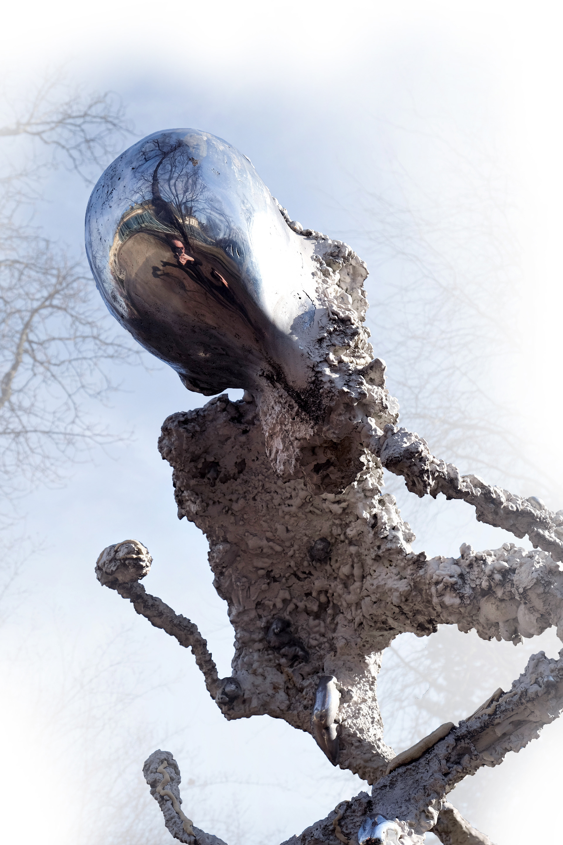 Large-scale sculpture from the Non–Humans series by Jan Gostyński, cast in bronze and aluminum with structural steel elements. The work takes the form of a hybrid, biomorphic figure with an irregular, expanding surface that evokes both organic growth and eroded matter. Shown outdoors at the Museum of King Jan III’s Palace at Wilanów, the sculpture stands in visual dialogue with the surrounding historical architecture and landscaped gardens, emphasizing the contrast between its contemporary, fragmented form and the classical setting.