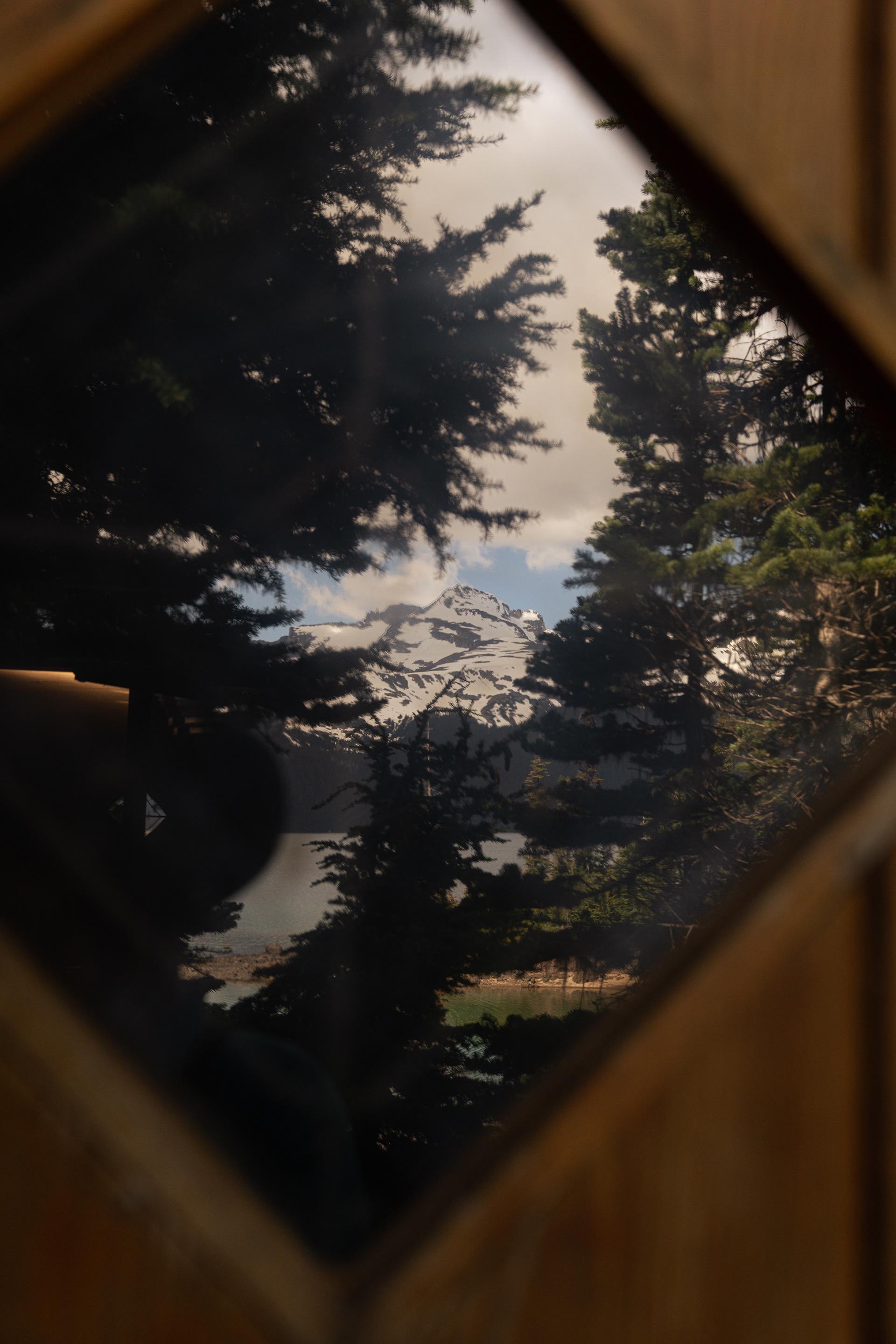 Garibaldi lake reflects in the ranger cabin window