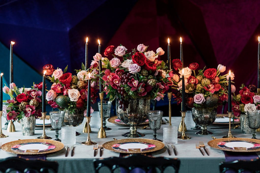 A gorgeous tablescape of jewel tones and antique gold accents, tied together with vintage elements